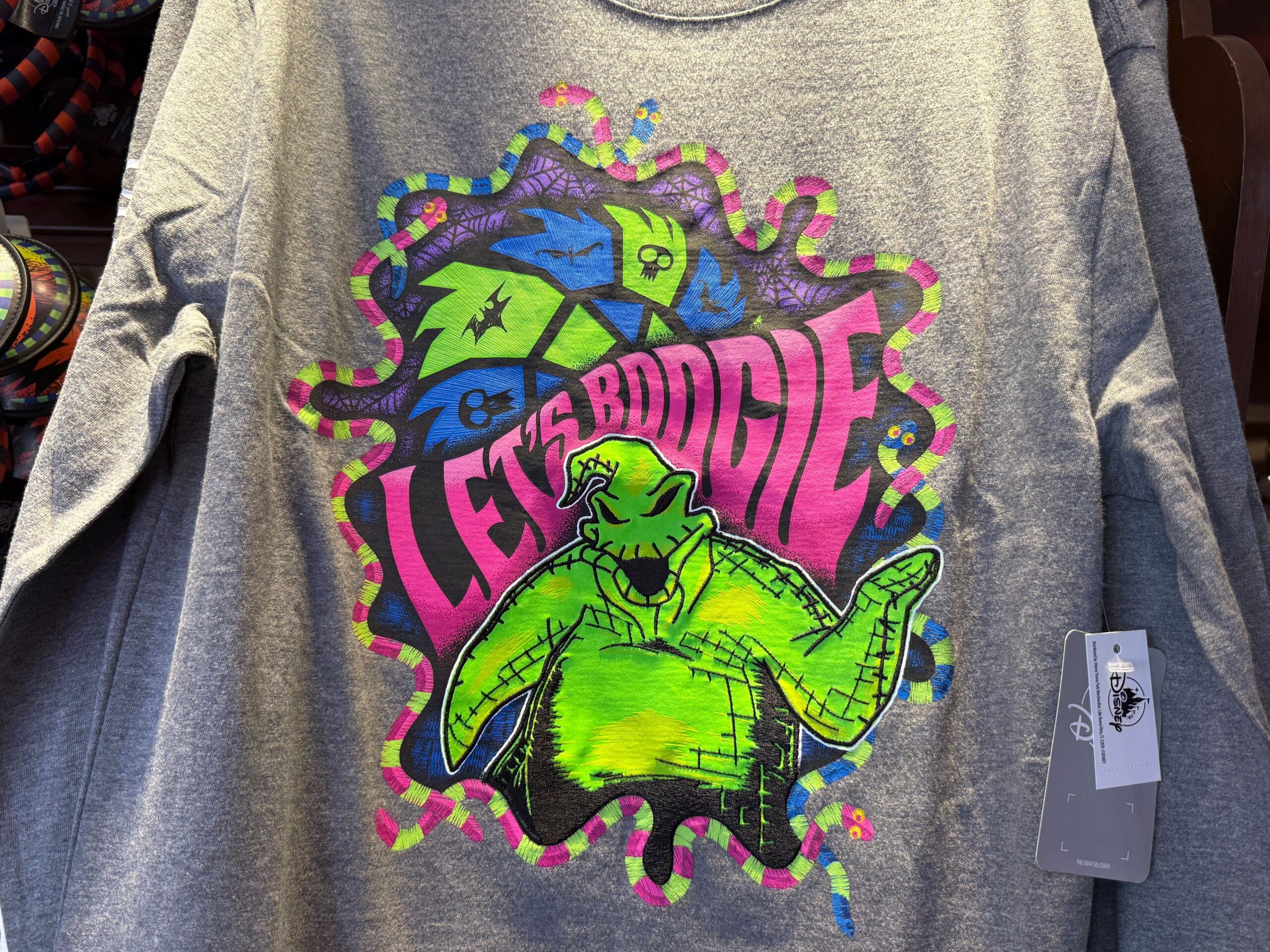 Gray shirt featuring neon green Oogie Boogie, dice, and snakes—perfect The Nightmare Before Christmas merchandise.