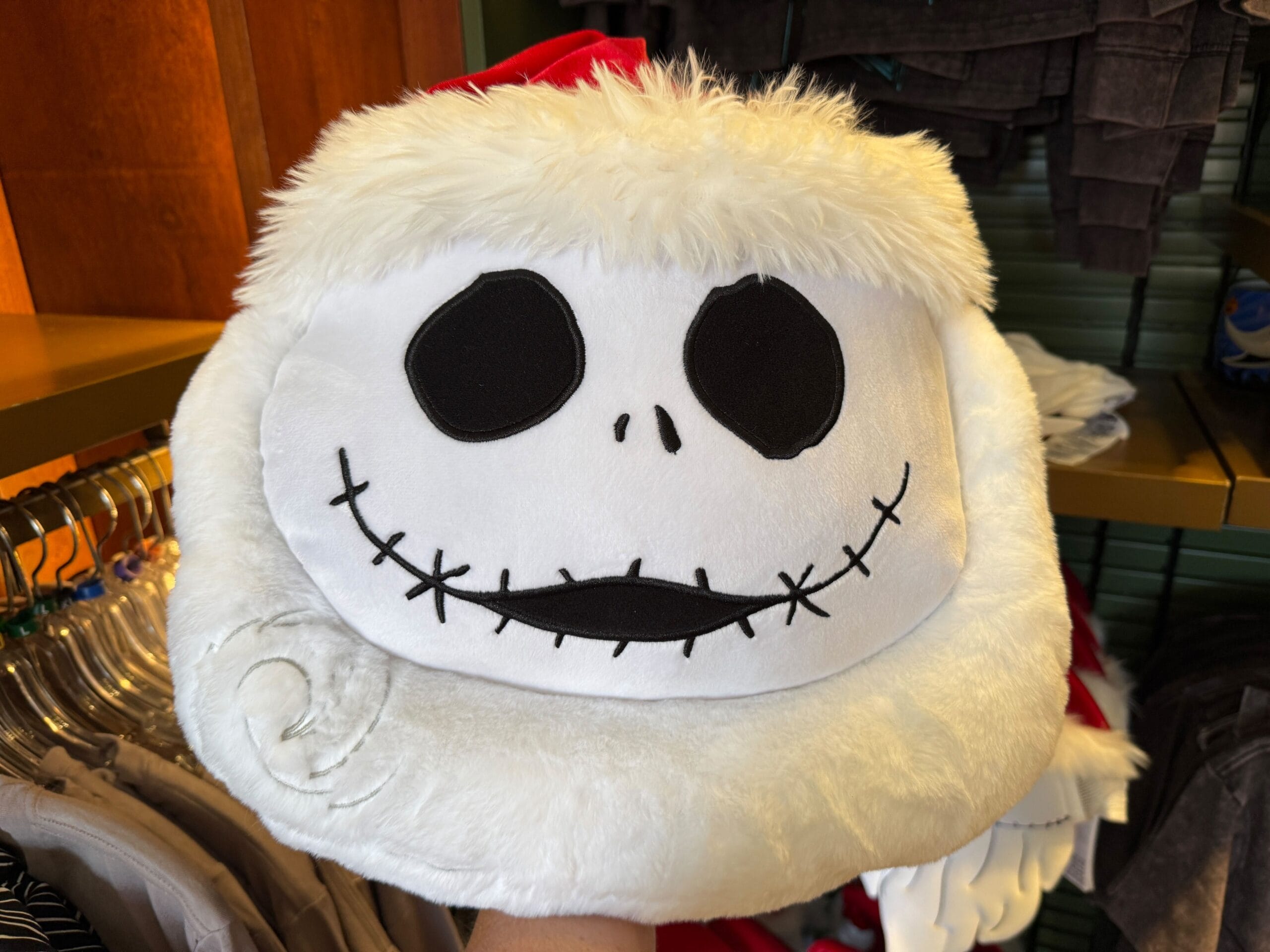 A plush Santa hat featuring Jack Skellington's face—perfect Nightmare Before Christmas merchandise for fans.