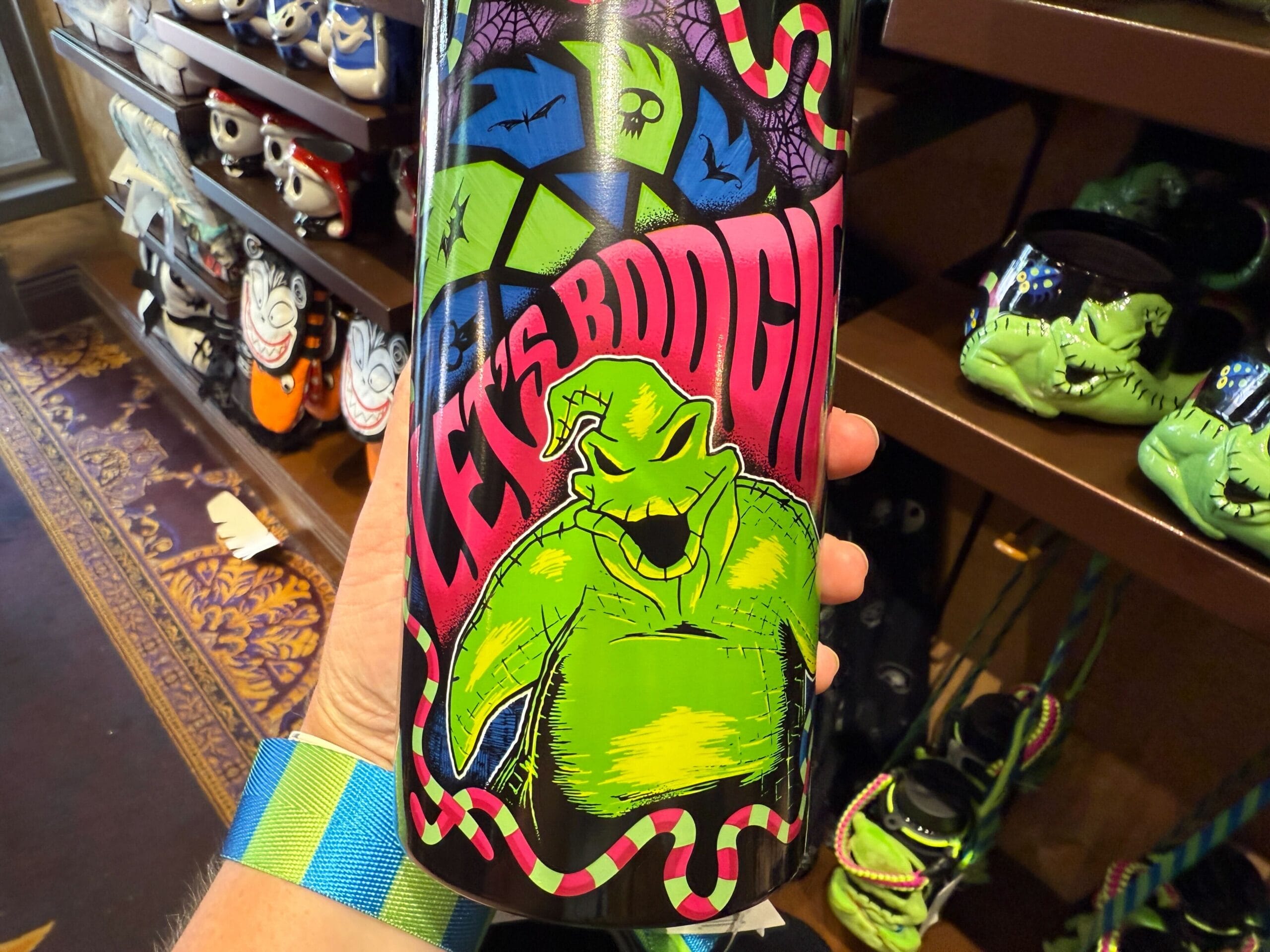 A colorful Nightmare Before Christmas bottle featuring Oogie Boogie and "Let's Boogie" in bold letters—fun new merchandise!