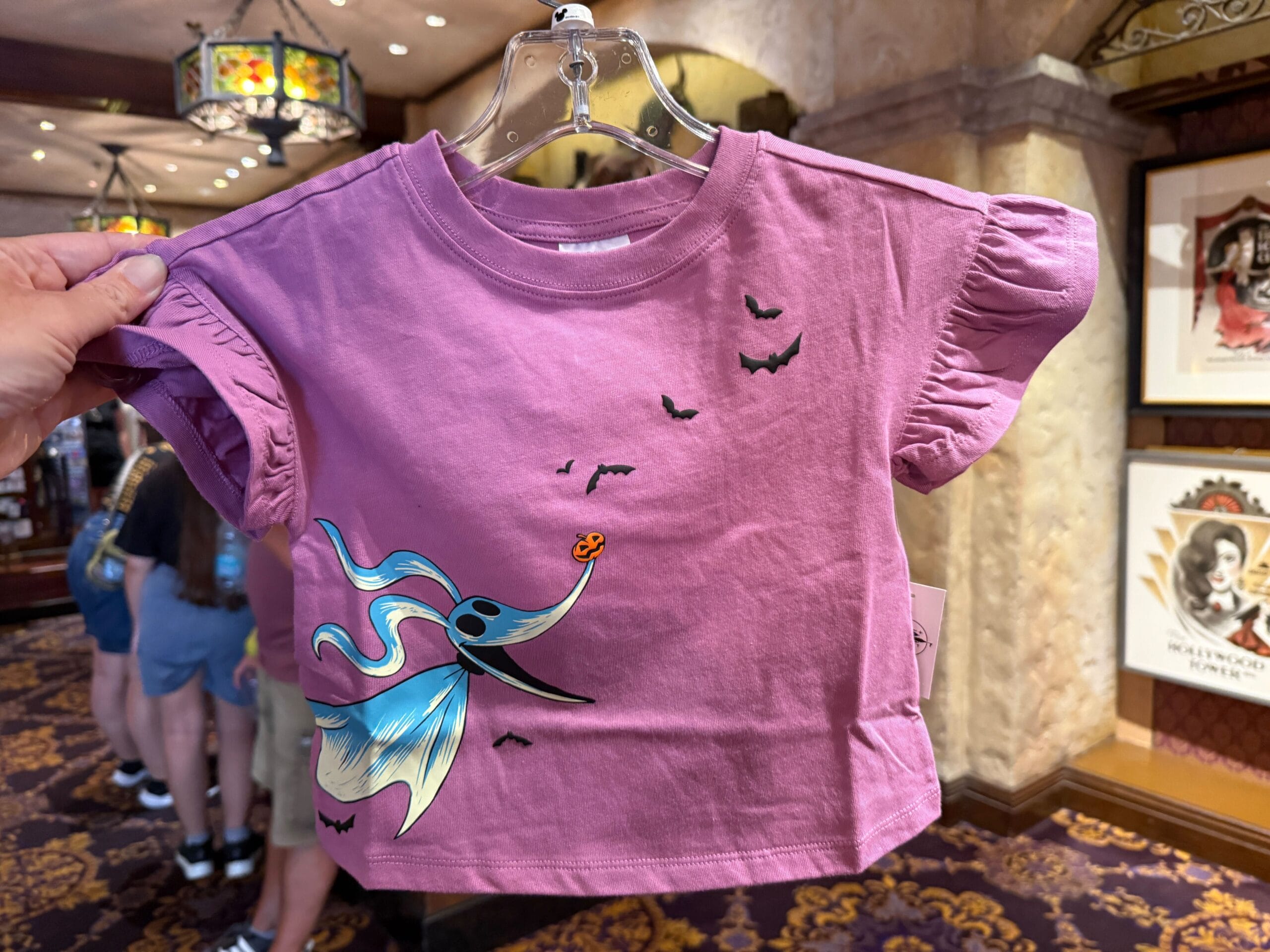 A purple toddler shirt featuring Zero the ghost dog and bats, perfect for Nightmare Before Christmas merchandise fans.