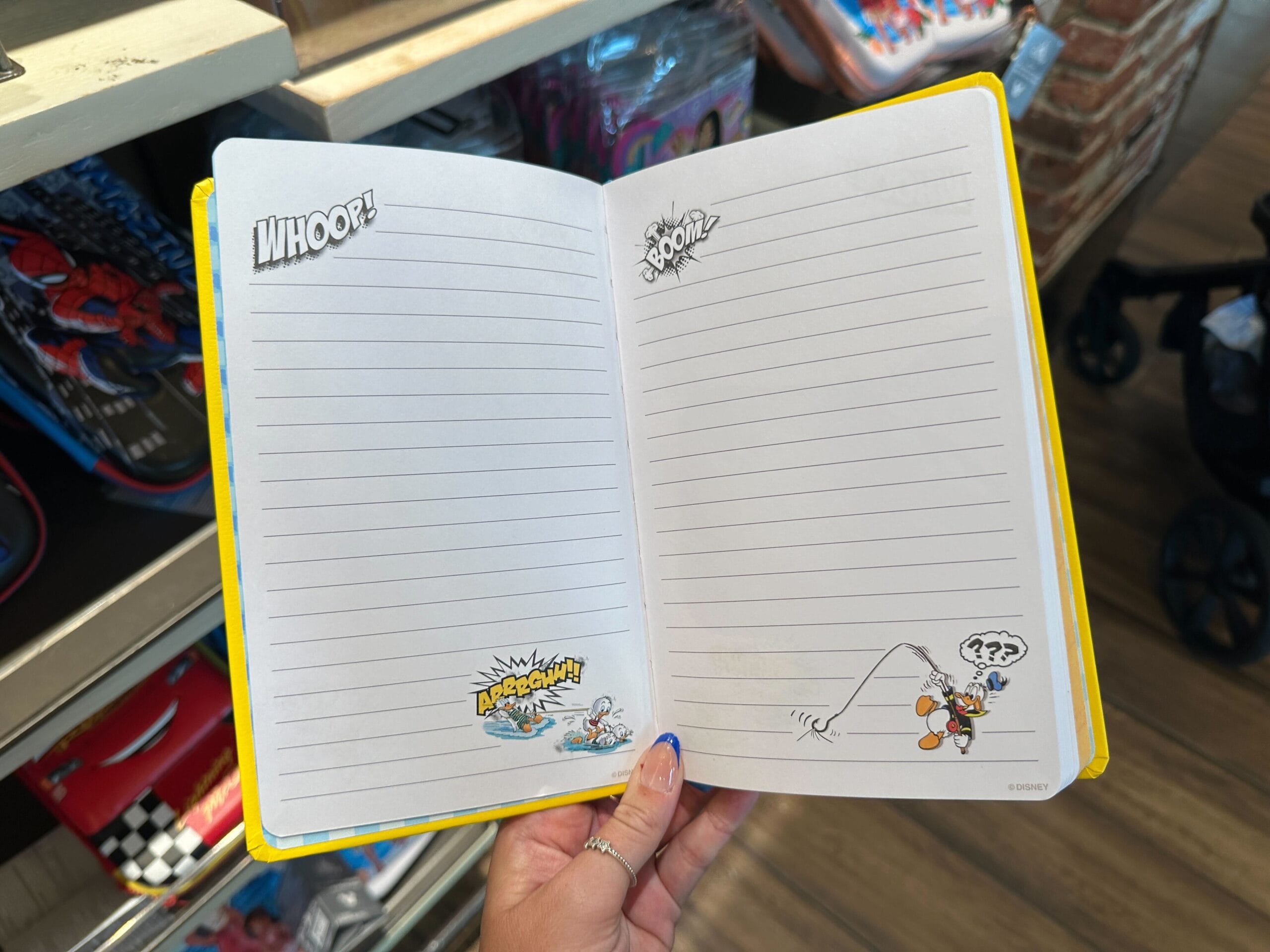 Open notebook with lined pages and comic-style Donald Duck—fun Disney merchandise for any Walt Disney World fan!