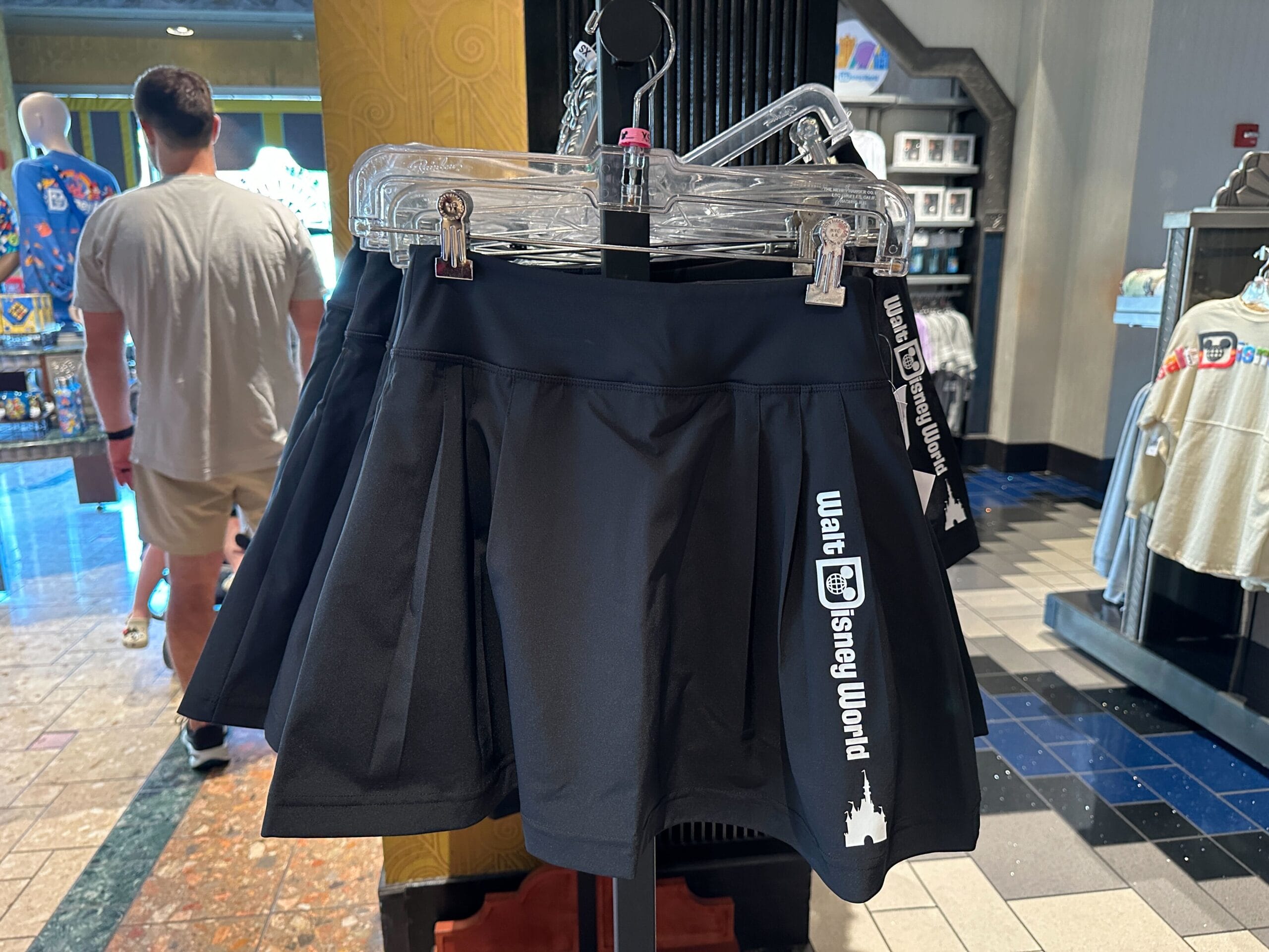 Black skirt with white "Walt Disney World" text and castle logo—perfect for Disney merchandise fans and new arrivals seekers.