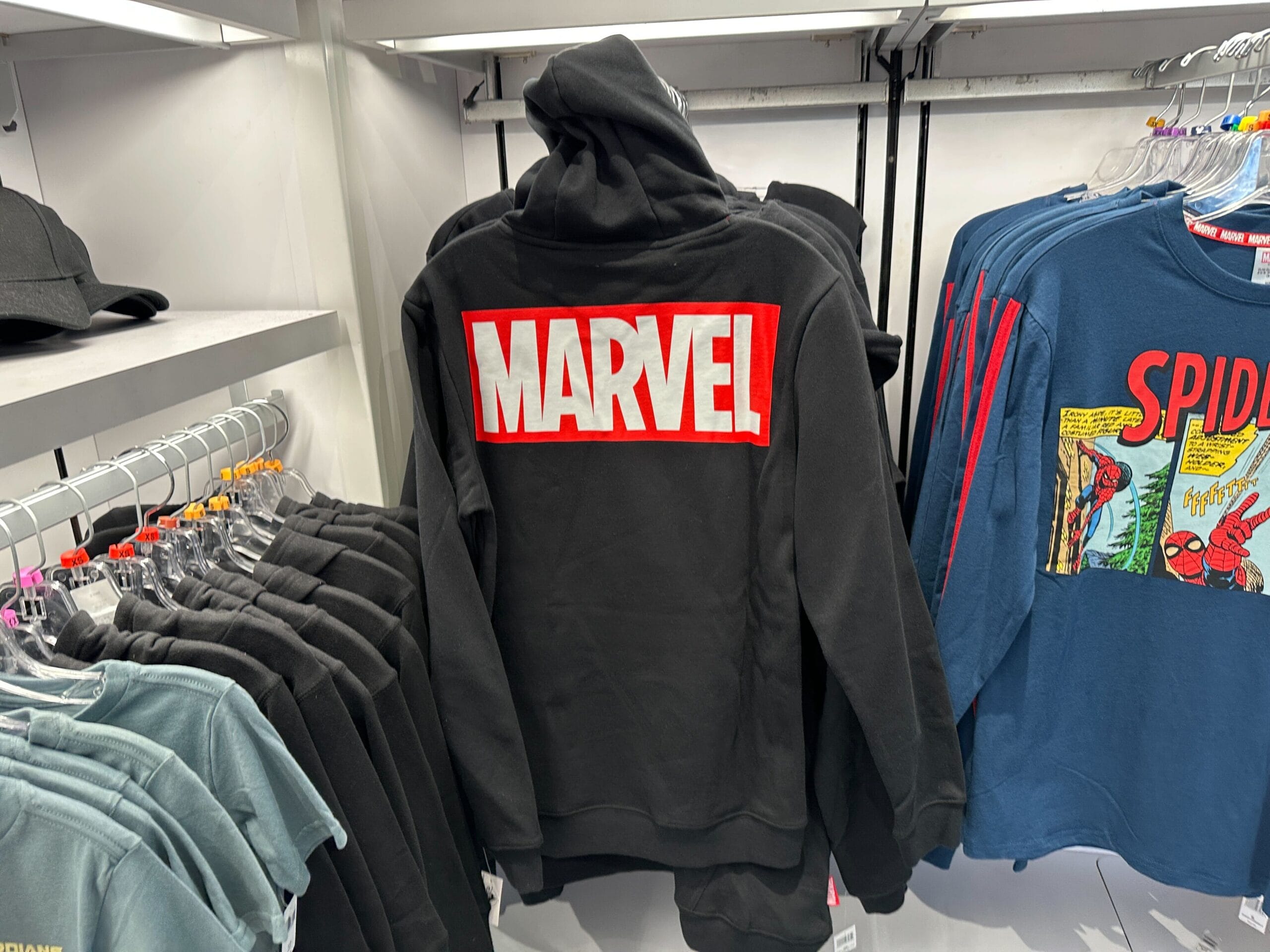 Black hoodie featuring a bold red and white "MARVEL" logo—perfect Marvel merchandise for any fan, displayed in-store.