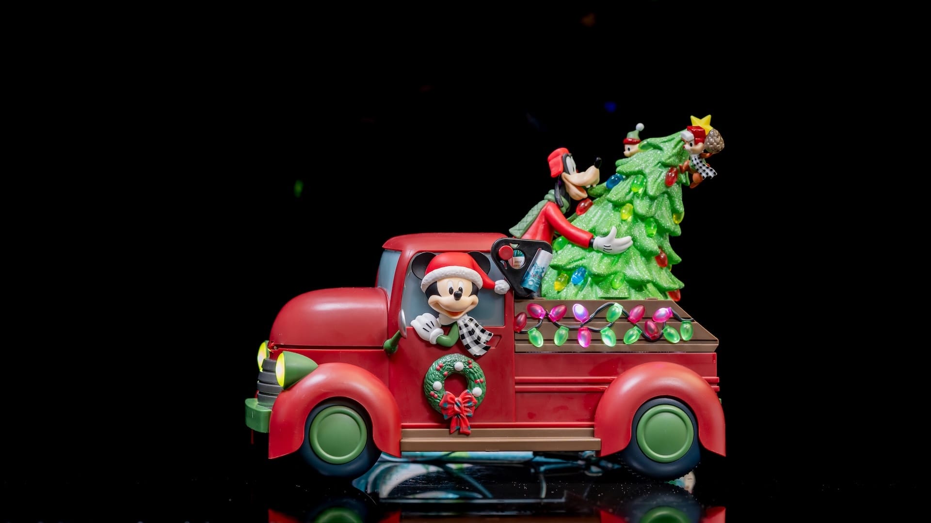 A red Christmas Tree Truck toy featuring a cartoon character on the back.