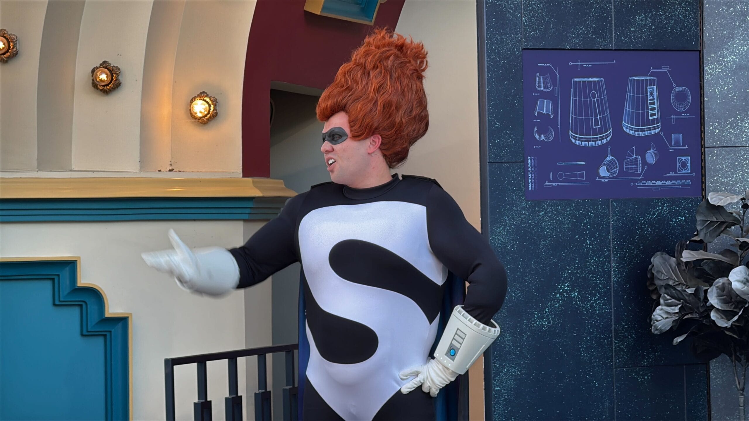 A person in a superhero costume at Disney's Oogie Boogie Bash gestures near the Treat Trail Locations.