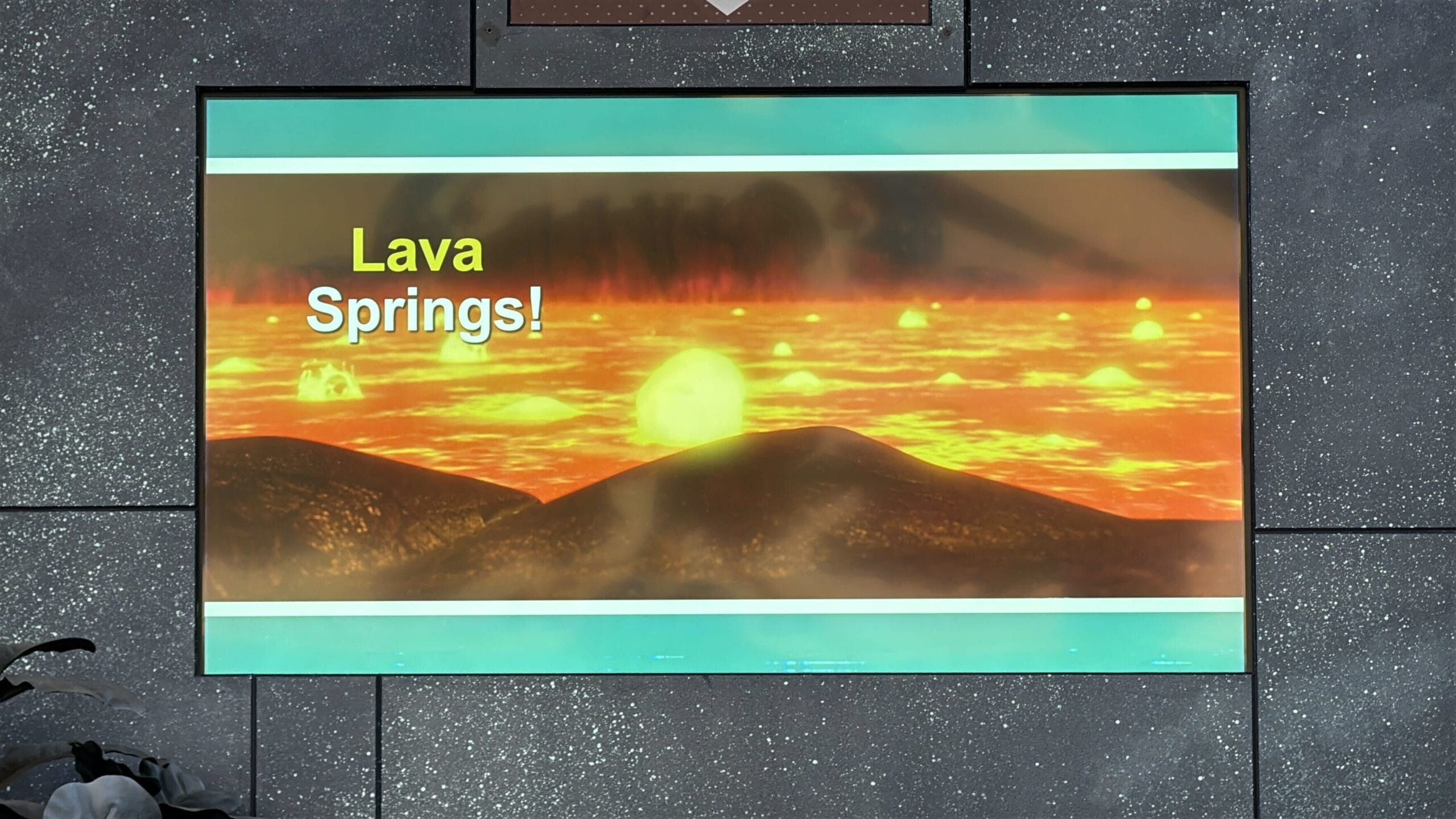 A digital sign reads "Lava Springs!" above an illustration of glowing lava flows, hinting at Villains from Oogie Boogie Bash.