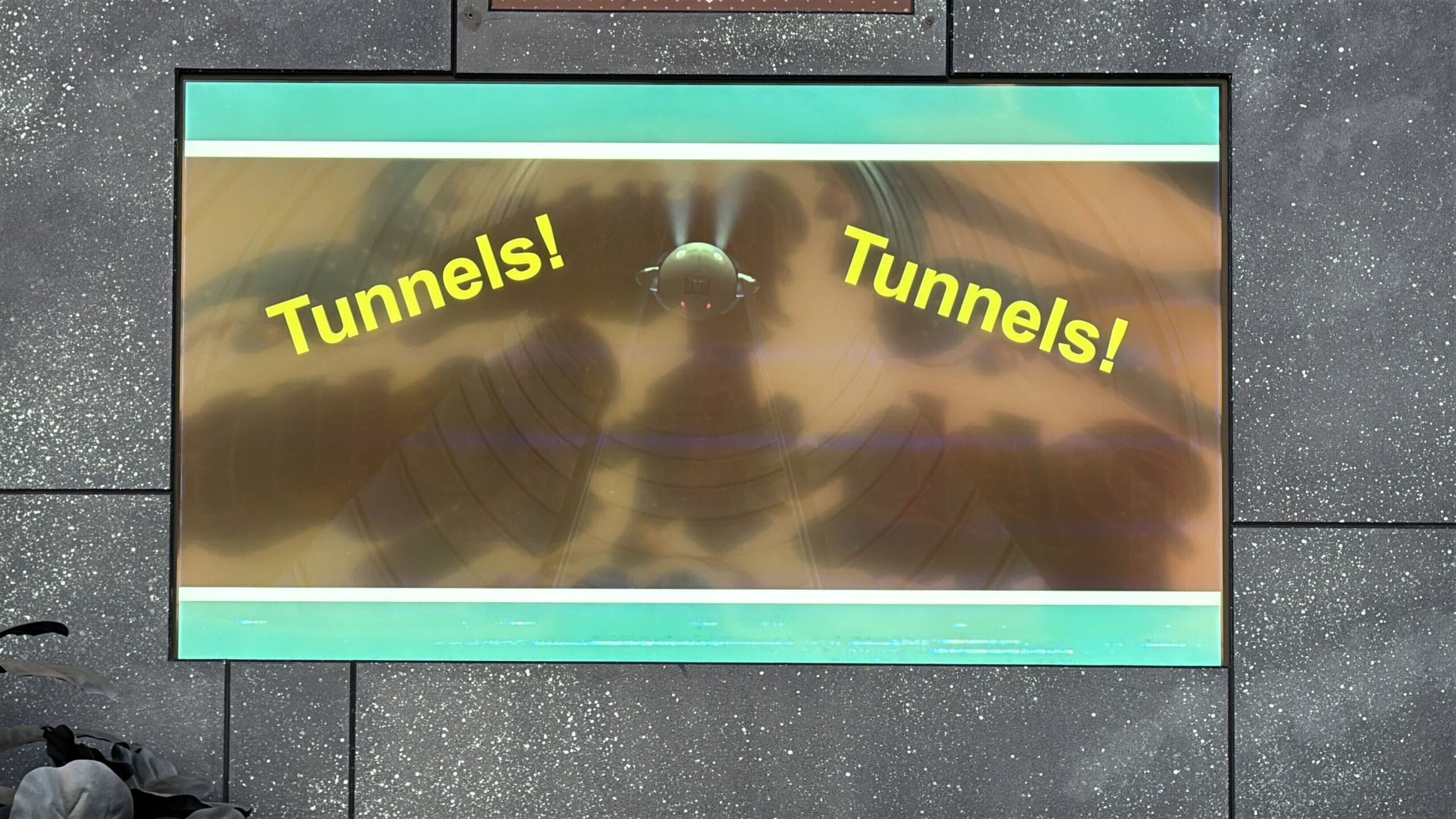 A screen displays the word "Tunnels!" twice with a tunnel image at Oogie Boogie Bash Treat Trail Locations.