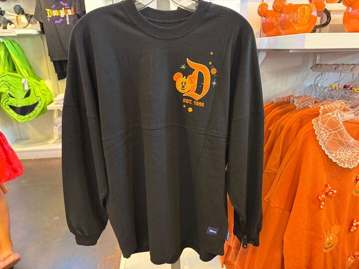 Black long-sleeve shirt with an orange Disneyland “D” and Mickey Mouse design—a perfect pick for Pumpkin Merch fans.