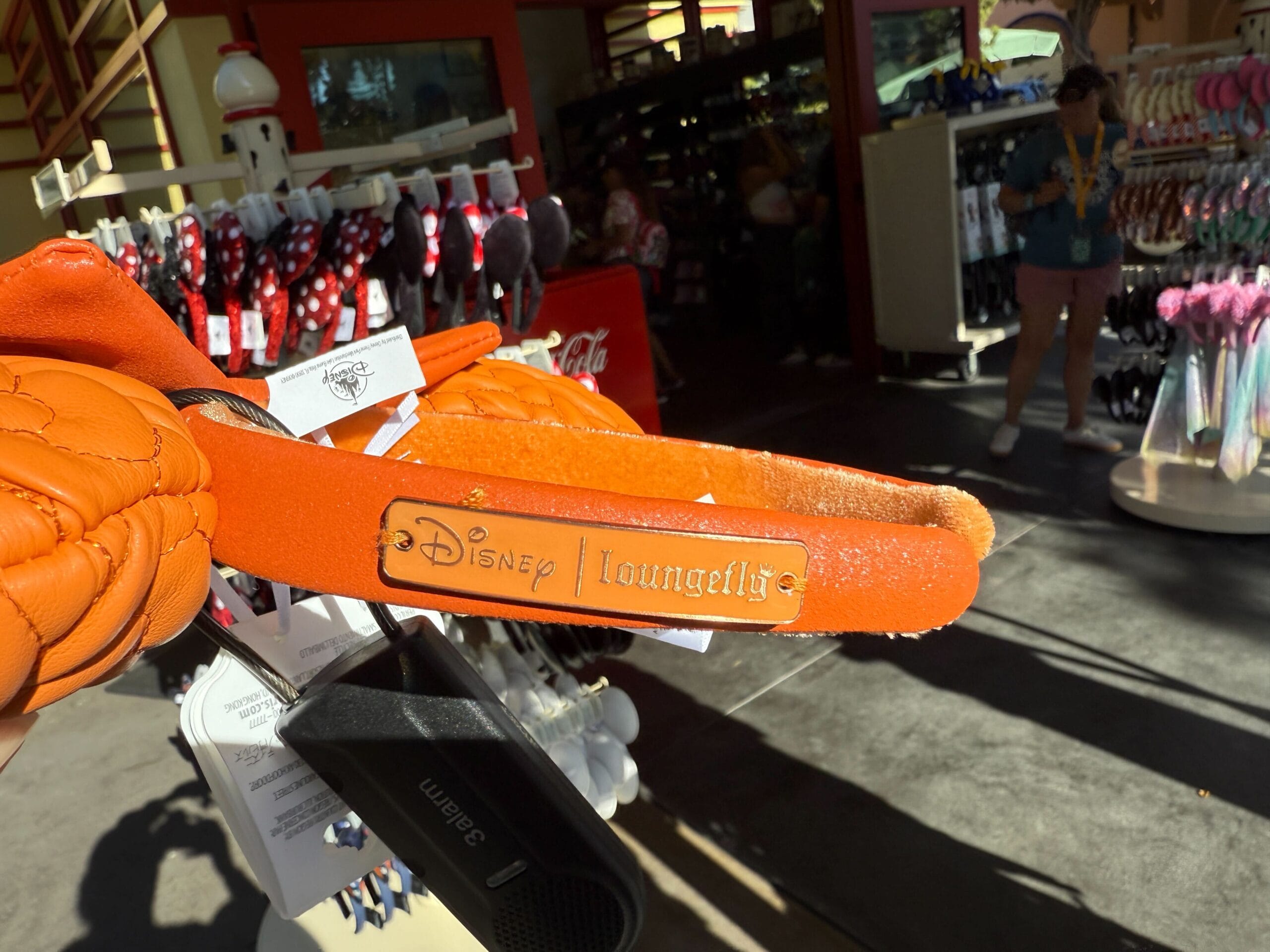 Close-up of orange Disneyland Halloween merchandise Mickey Mouse ears headband at a theme park gift shop.