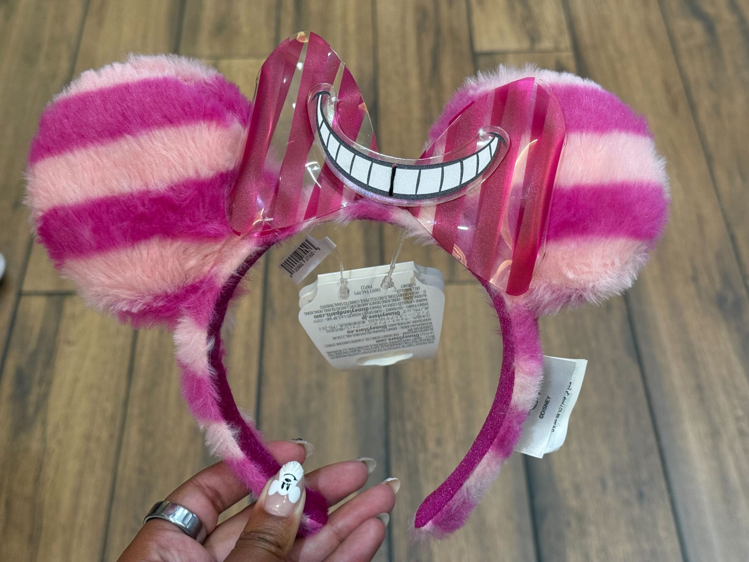 Plush Ear Headband with pink and purple stripes, cat ears, and a Cheshire Cat grin—perfect for Disneyland Resort fun!