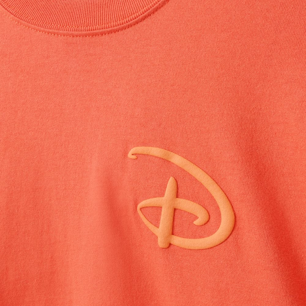 Coral t-shirt with an embossed stylized "D" logo, inspired by the Disney Store’s cozy fall and pumpkin spice vibes.
