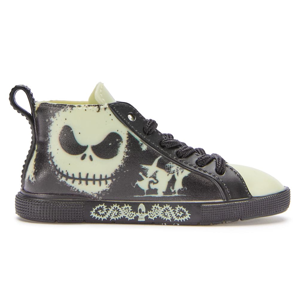 Black and glow-in-the-dark sneaker featuring Jack Skellington’s face and silhouettes of characters on the side.