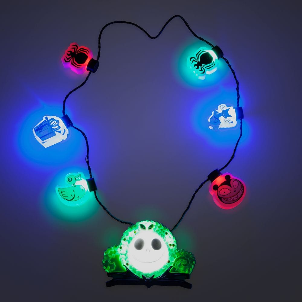 A string of multicolored lights shaped like “The Nightmare Before Christmas” characters on a dark background.