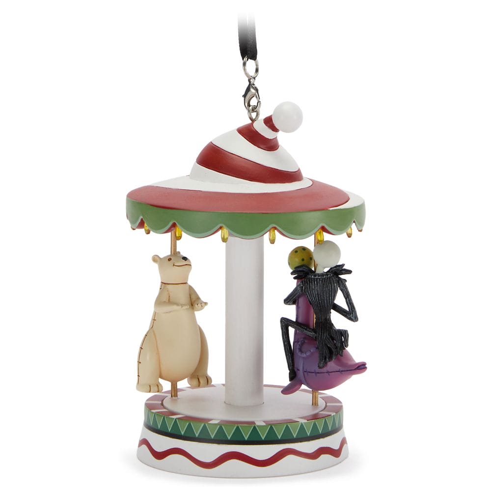 A Christmas carousel ornament with a polar bear and a purple-suited skeleton character under a striped canopy.