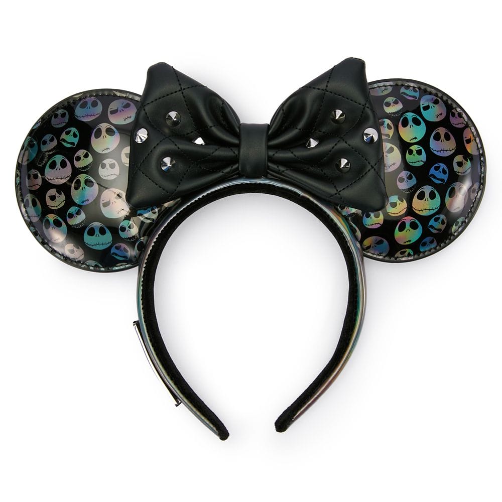 Black headband with mouse ears covered in holographic Jack Skellington faces and a black bow with silver studs in the center.