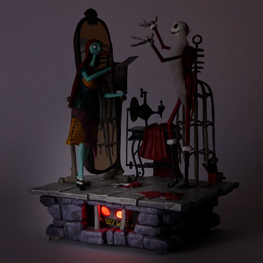 Sally and Jack Skellington stand in a dimly lit lab scene with eerie red light glowing from below.