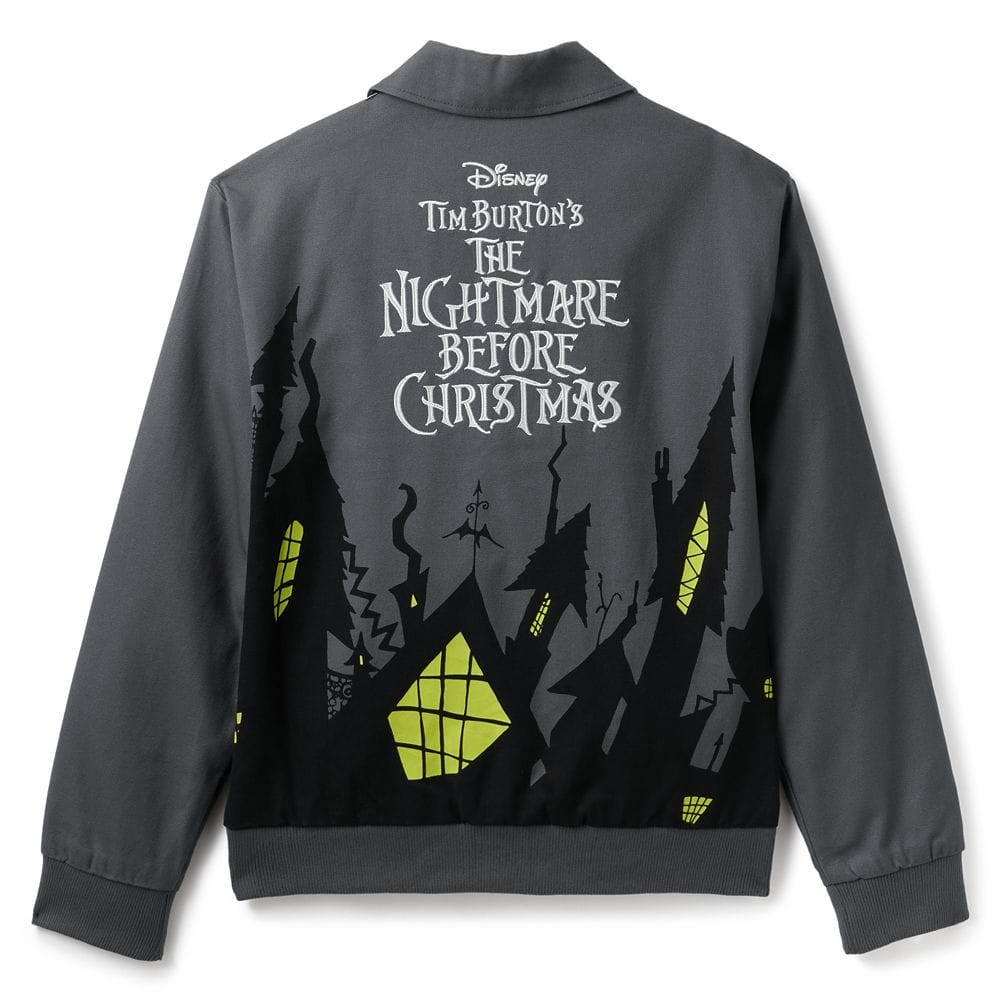 Dark jacket with yellow-lit spooky houses and "The Nightmare Before Christmas" text on the back, inspired by Tim Burton’s film.
