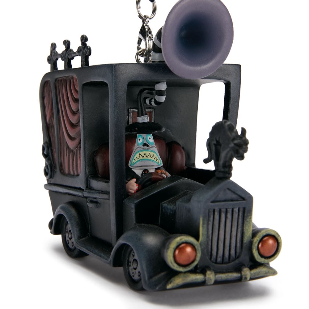 Cartoonish black hearse ornament with a blue-faced character driving and a large speaker on top.