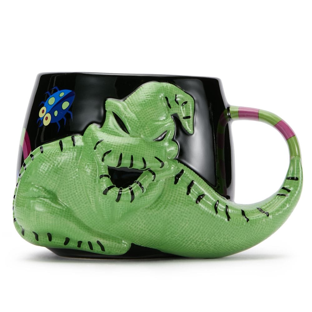 Black mug with a large, raised green character wrapping around it, featuring a bug detail and colorful handle.