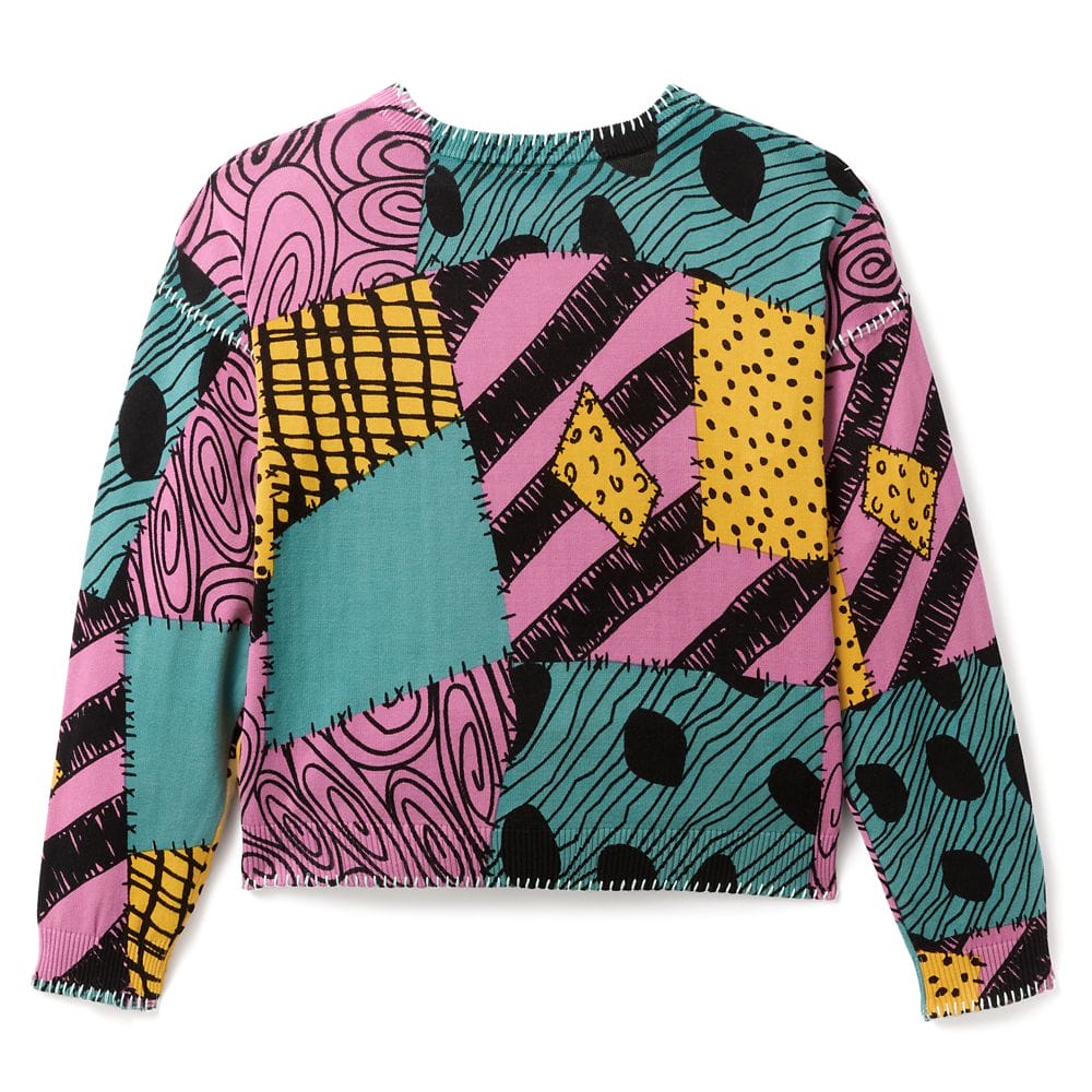 Colorful patchwork sweater with pink, teal, yellow, and black geometric and swirl patterns, inspired by a quirky, bold design.