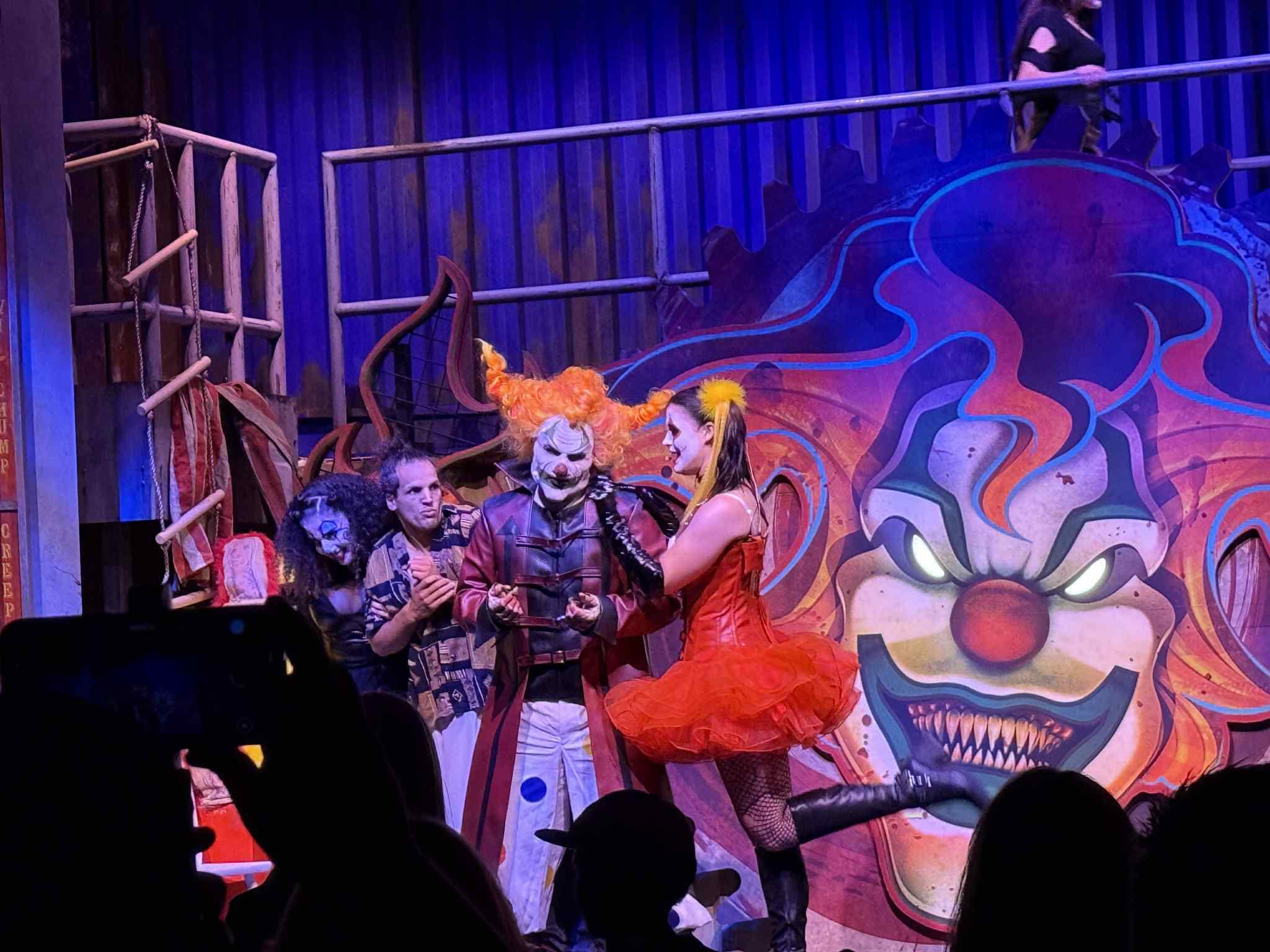 FIRST LOOK: Performers in spooky costumes stand on a colorful stage at Universal Horror Unleashed Las Vegas.