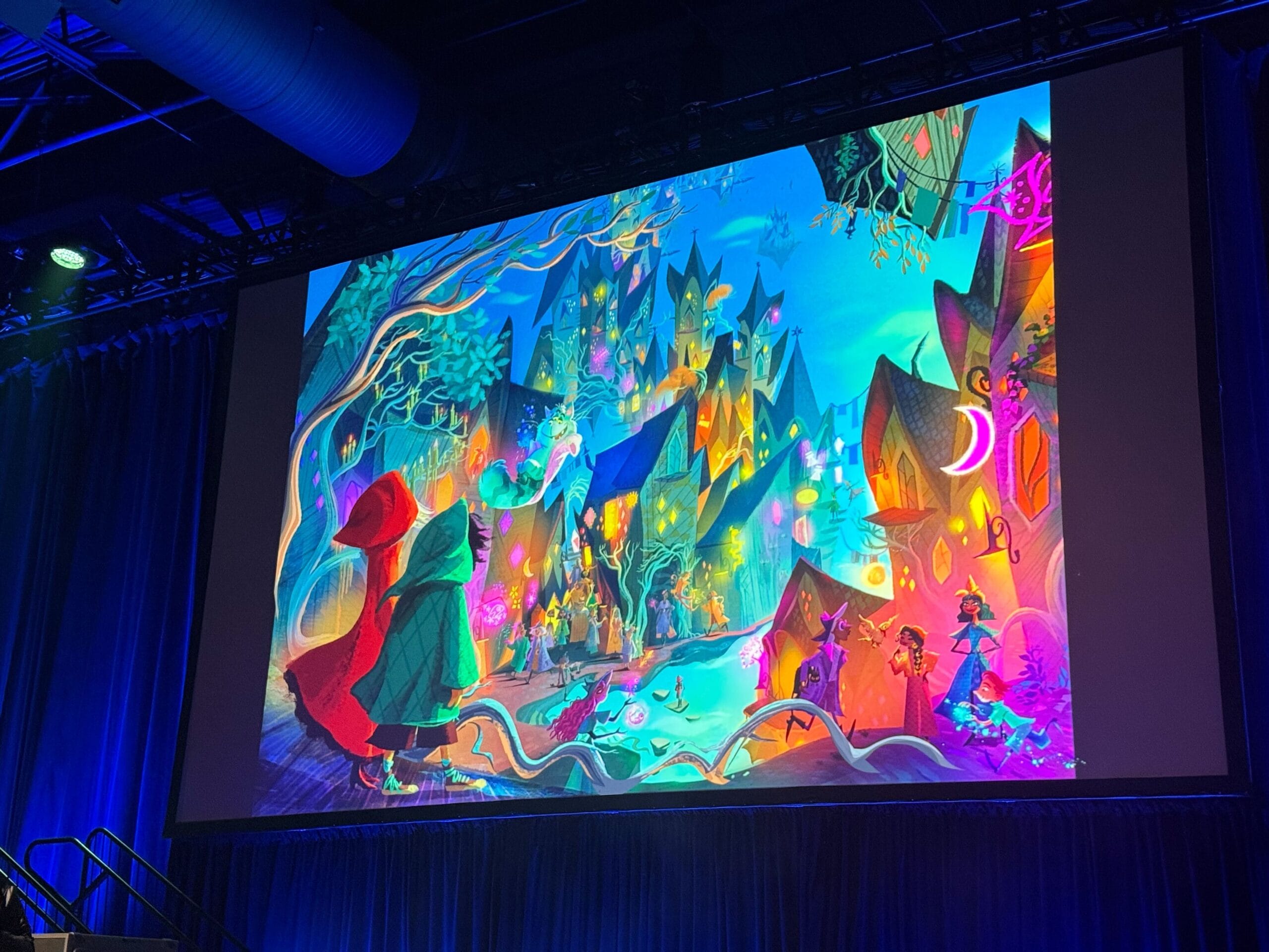 Colorful, whimsical fantasy artwork from a new Disney animated film displayed on a large screen in a darkened theater.