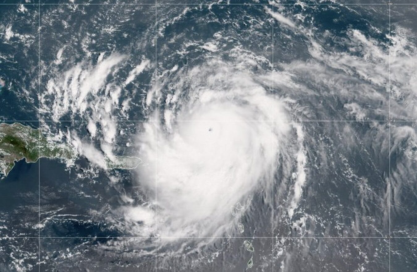Satellite image of Hurricane Erin, recently upgraded to Category 5, over the Atlantic near the Caribbean islands.