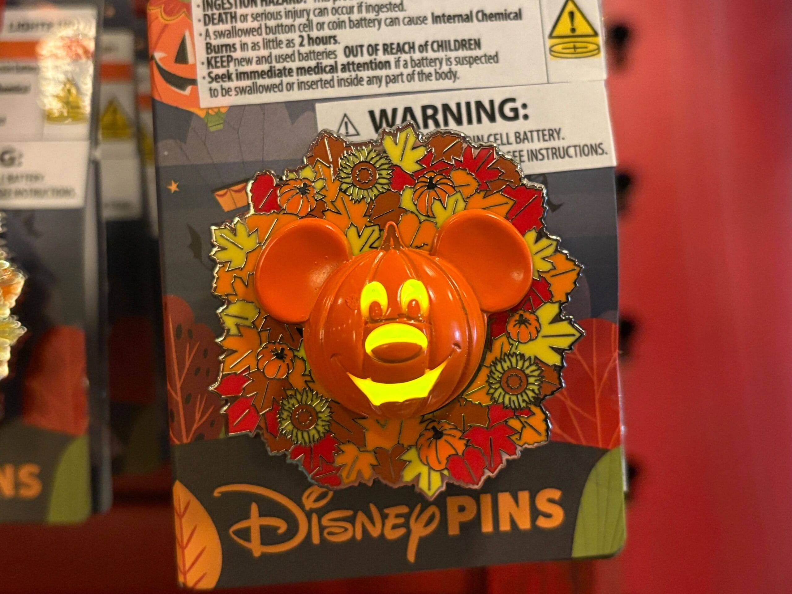 A Disney pin from 2025 Halloween Merchandise featuring a Mickey Mouse pumpkin, displayed on a Walt Disney World card.