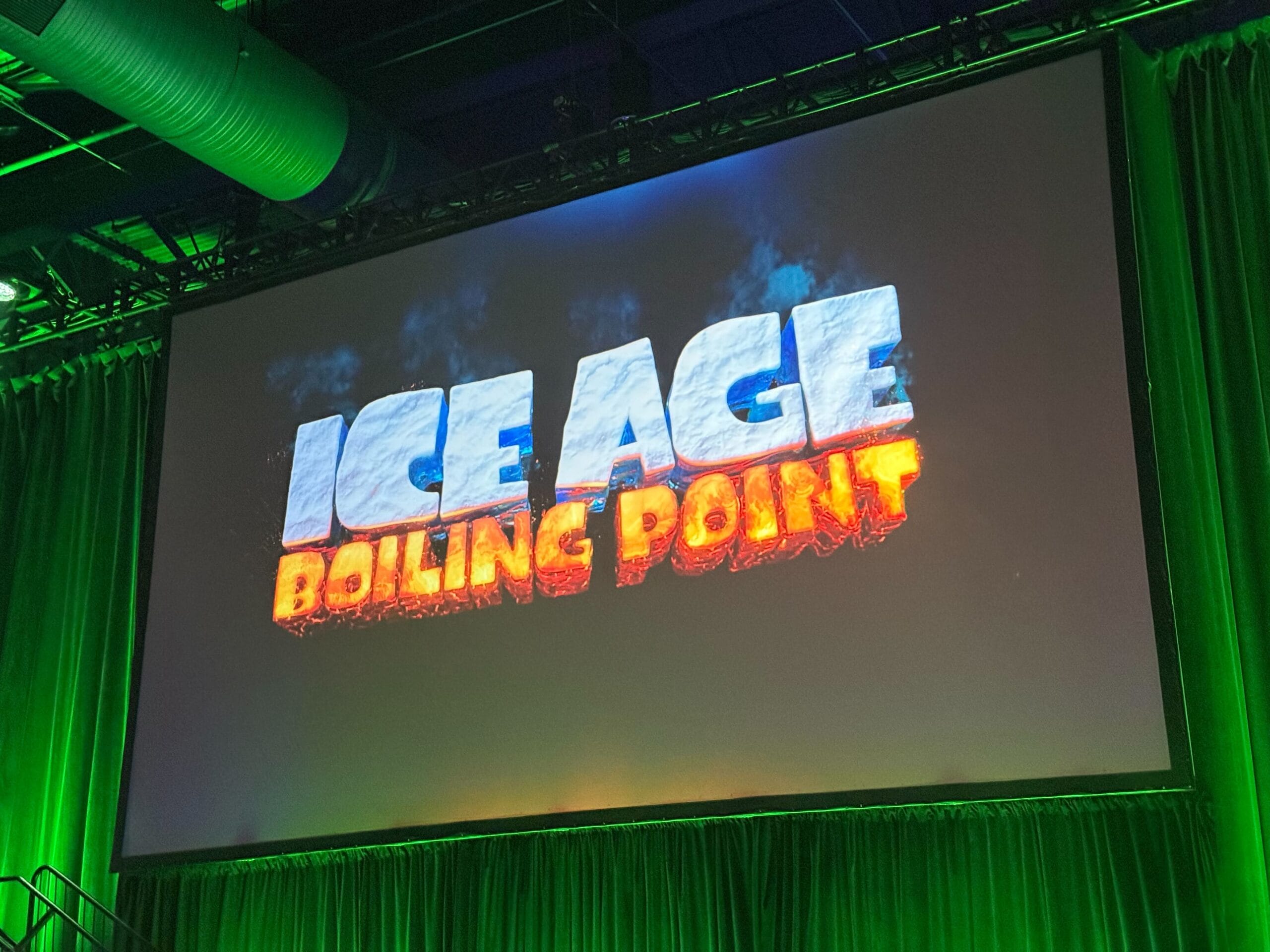 Large screen at Destination D23 displays "ICE AGE BOILING POINT" in icy and fiery letters amid green lighting.