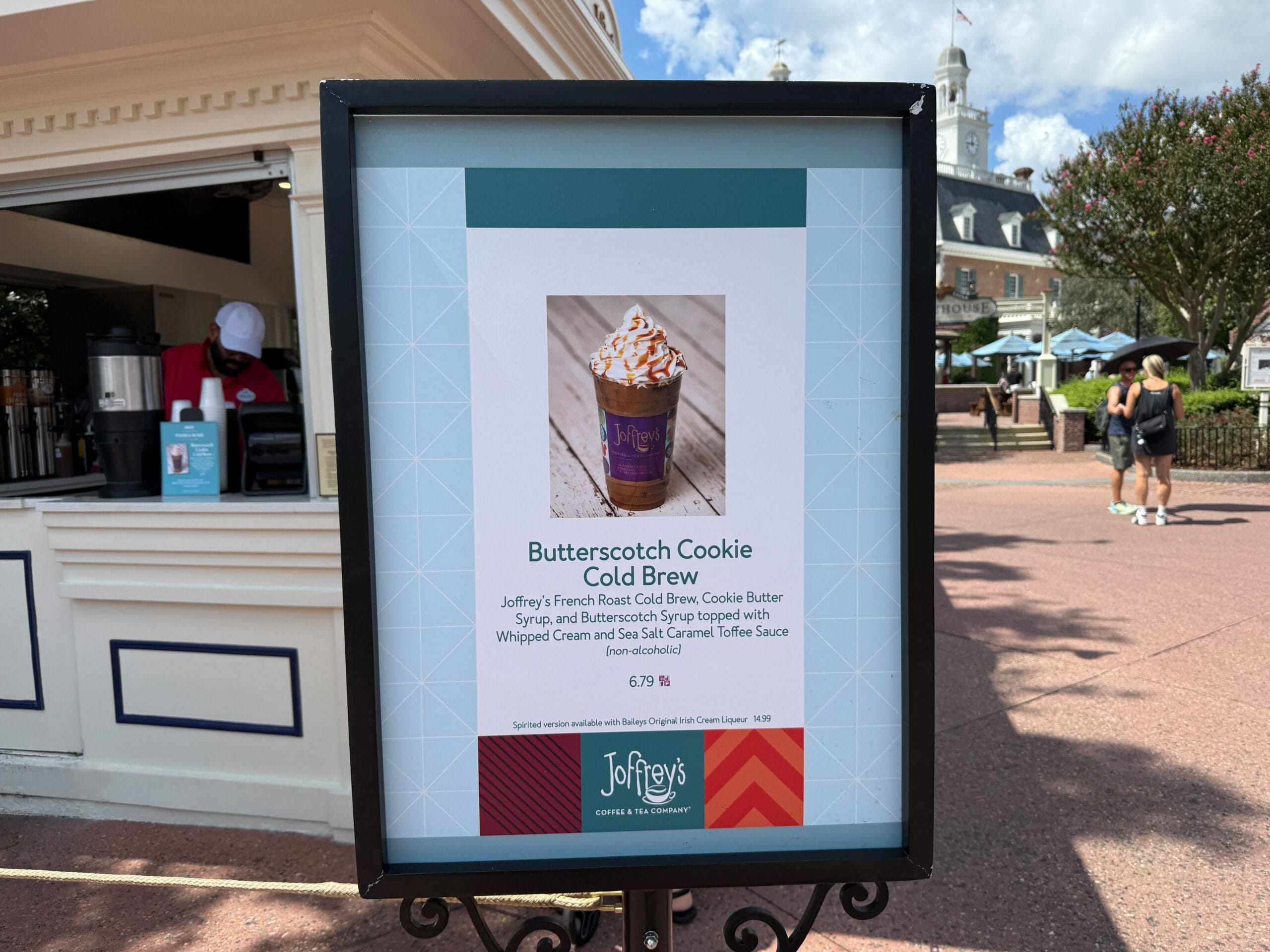 Sign advertising Joffrey’s Butterscotch Cookie Cold Brew at Food & Wine, pictured outdoors near a coffee stand.