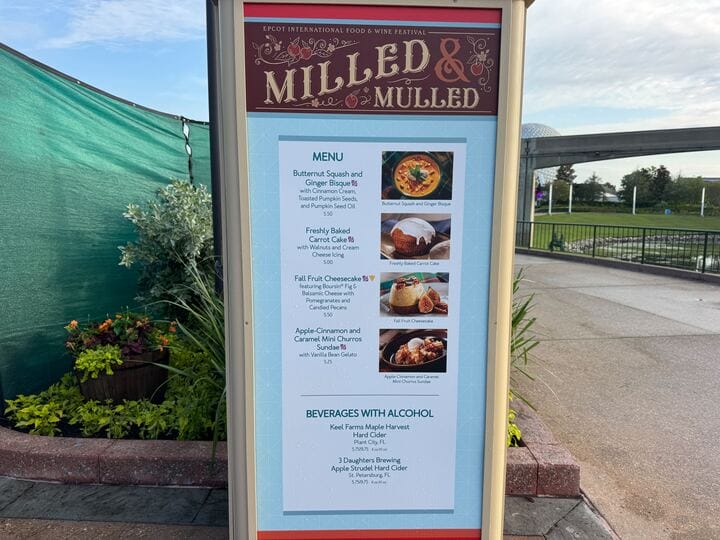 Menu board at Epcot’s Milled & Mulled booth listing Food & Wine Festival items and specialty drinks.