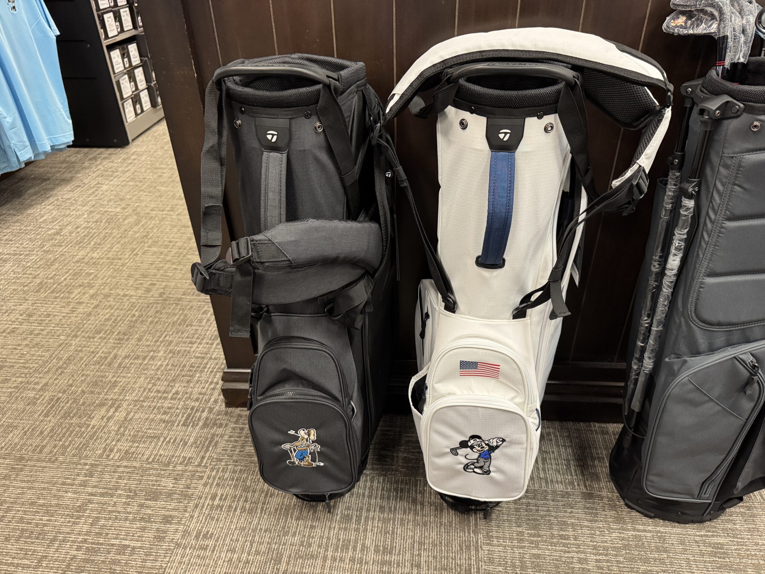 Black and white golf bags with bulldog mascots and a 2025 patch, perfect for your Hollywood Studios photo report.