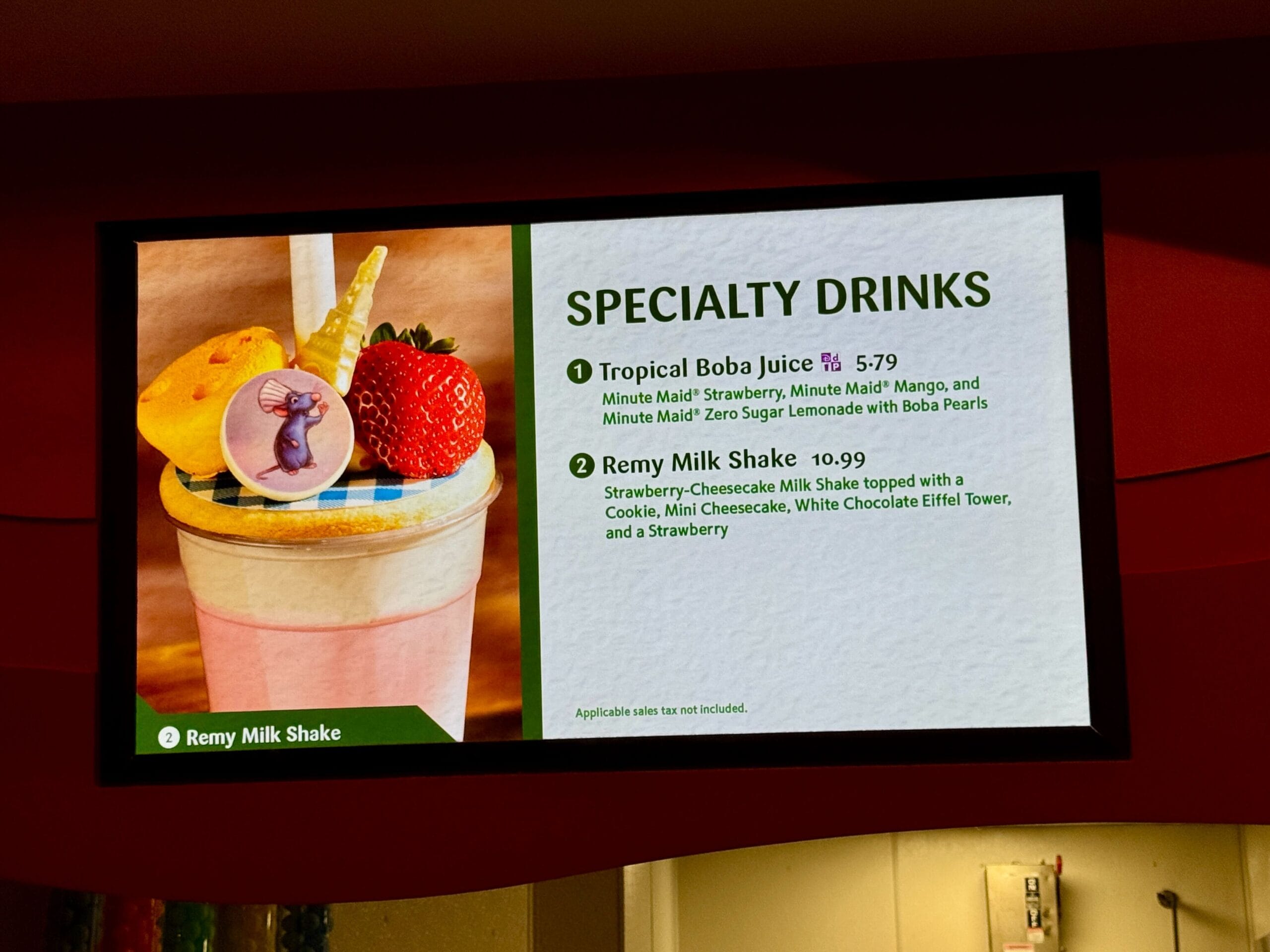Digital menu displays specialty drinks at Food & Wine, featuring a Remy Milk Shake topped with sweets and a strawberry.
