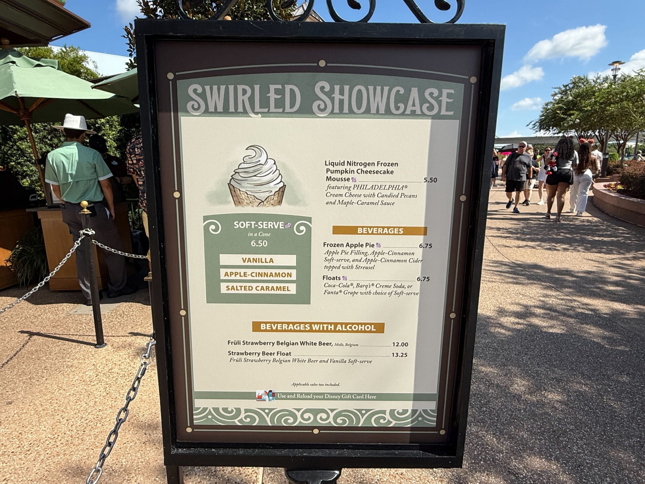Menu board for Swirled Showcase highlights New Food & Wine, soft-serve, beverages, and cocktails outdoors on a sunny day.