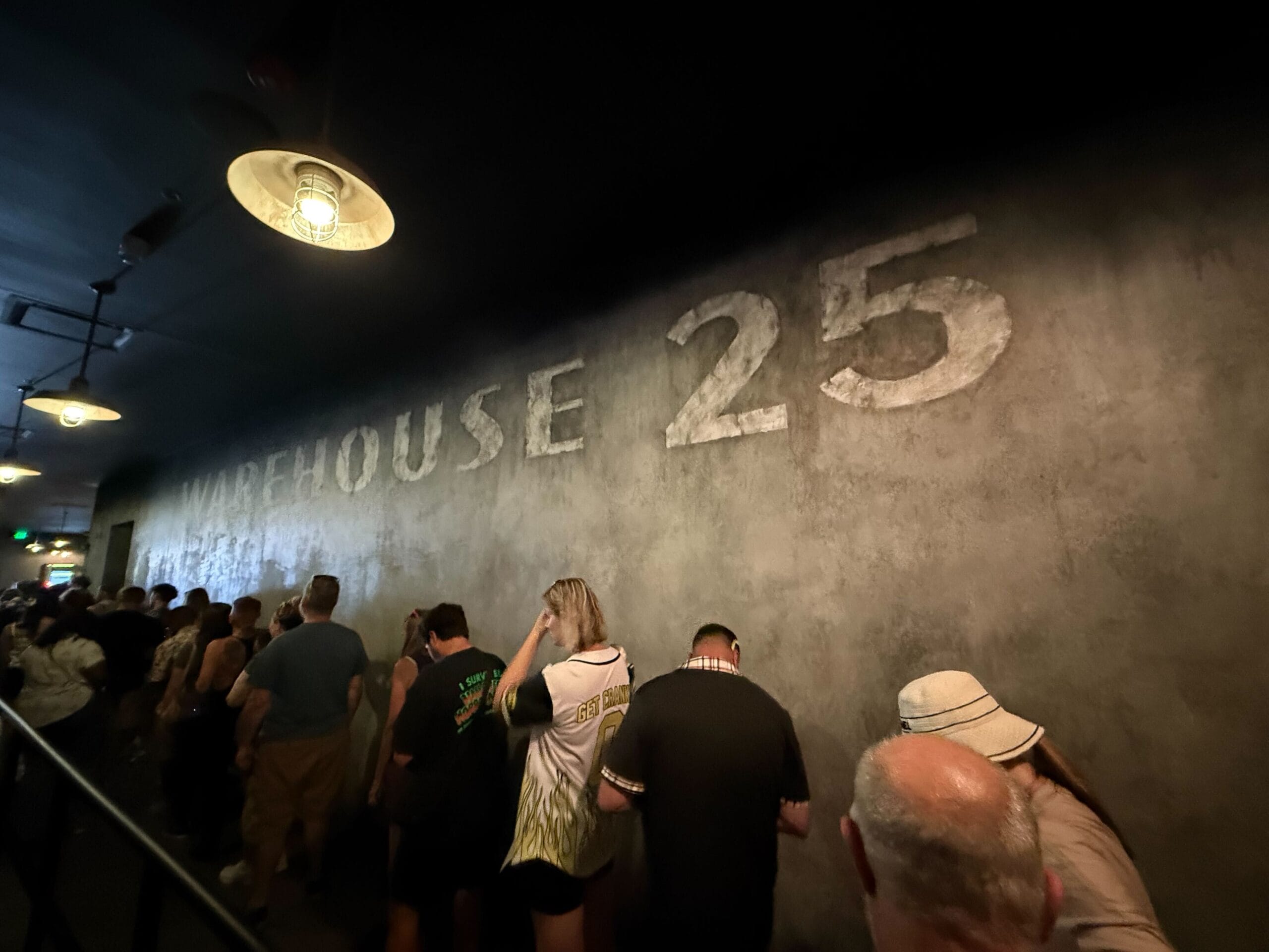 People stand in line inside a dimly lit hallway for the Universal Horror Unleashed full tour in Las Vegas.