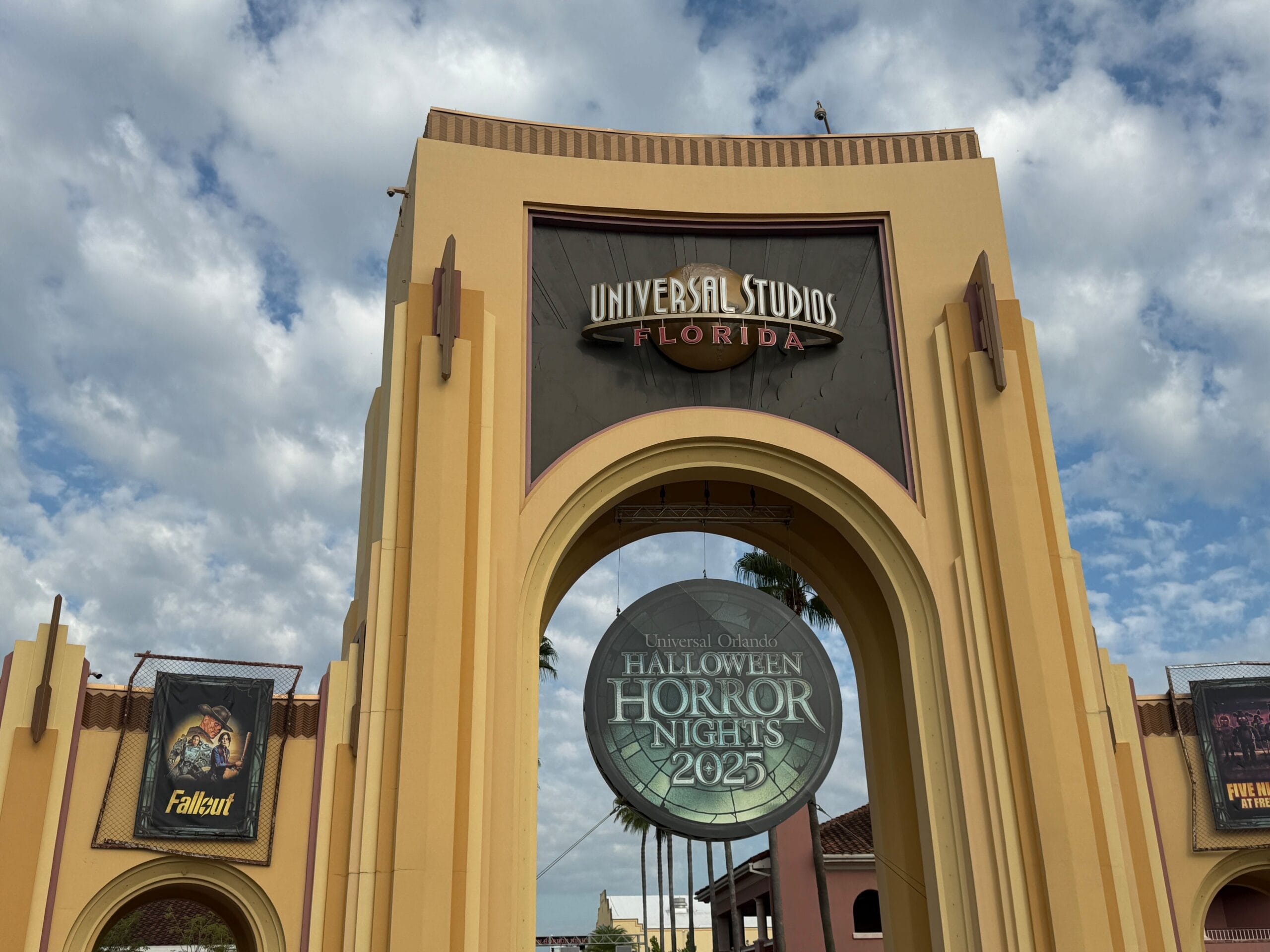 Universal Studios Florida entrance with a large sign for Halloween Horror Nights 2025 and banners on both sides.