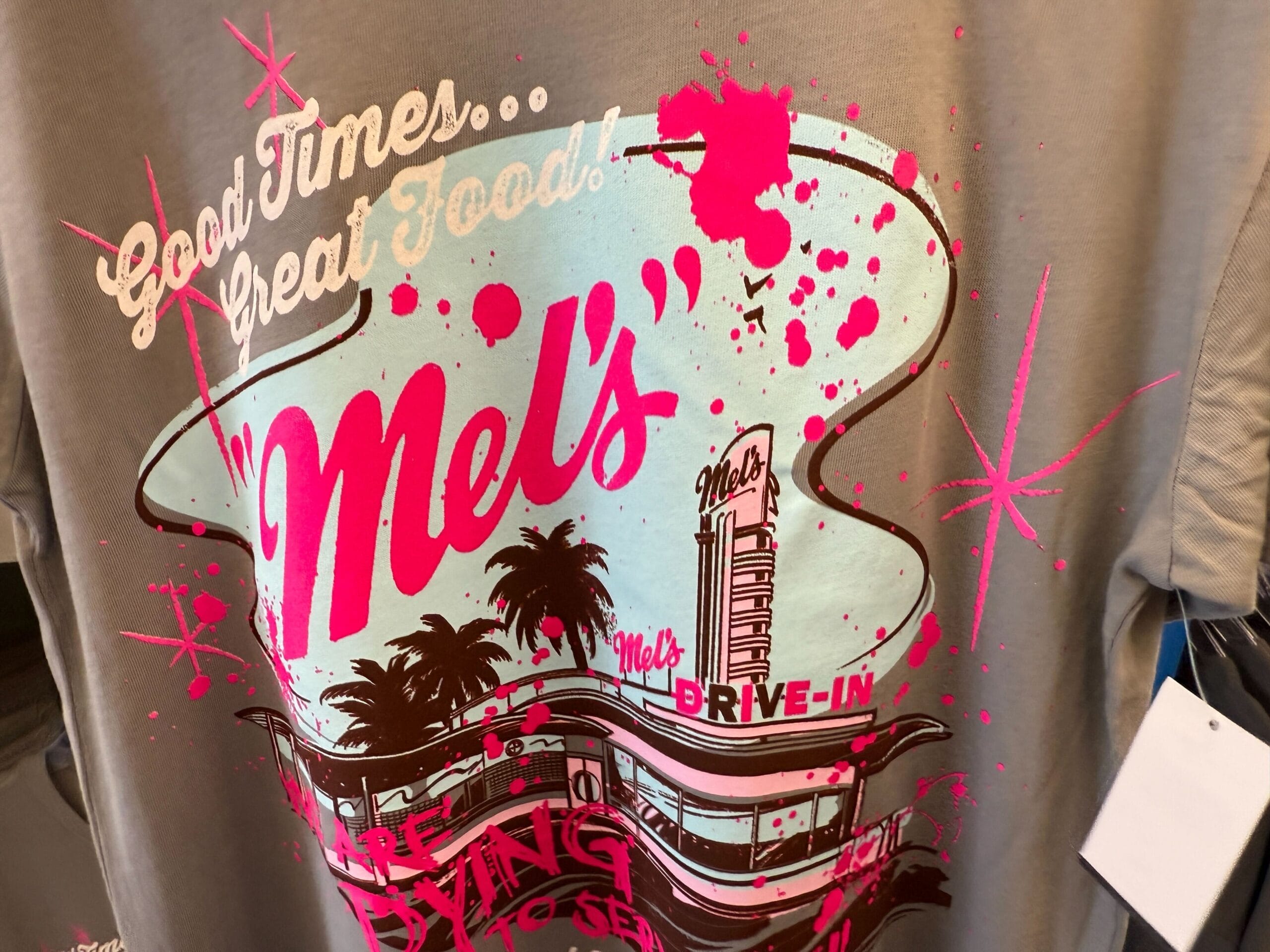 Gray t-shirt featuring a colorful Mel’s Drive-In graphic—part of our exclusive Mel's Merch collection!