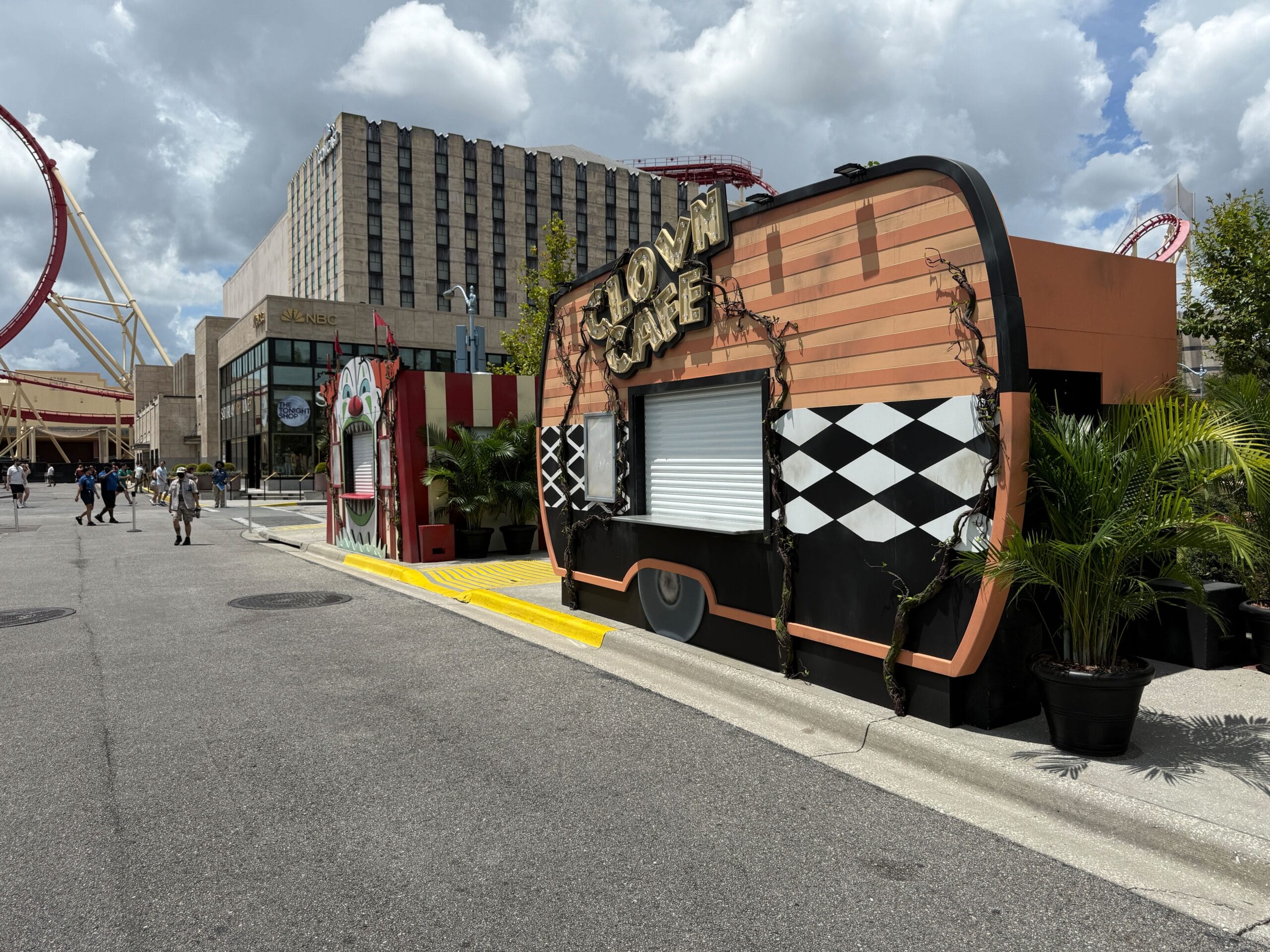 A closed food truck labeled "Crown Café" sits near a theme park, nodding to Terrifer's Clown Cafe at Halloween Horror Nights 34.
