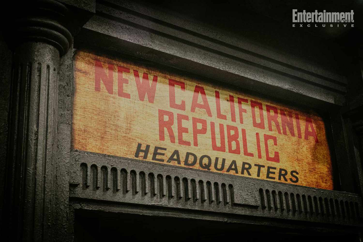 Weathered "New California Republic Headquarters" sign on an old building; first look for Entertainment Weekly above.