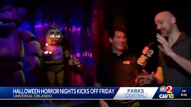 Two TV reporters react to animatronic characters in a Haunted House at Universal’s Halloween Horror Nights event.
