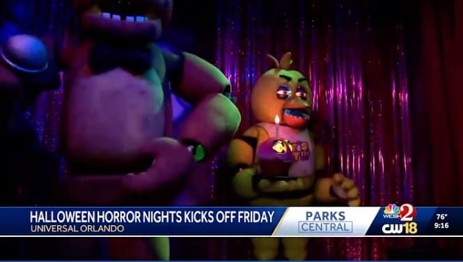 Animatronic characters perform on stage with purple lights at Halloween Horror Nights, evoking Five Nights at Freddy's vibes.