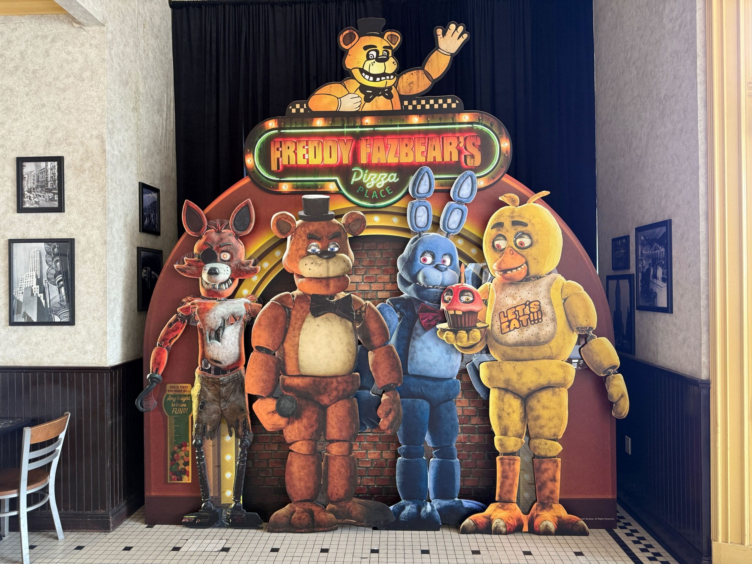 Cardboard standee of Five Nights at Freddy’s characters in a FNAF-themed restaurant with Freddy Fazbear and friends.
