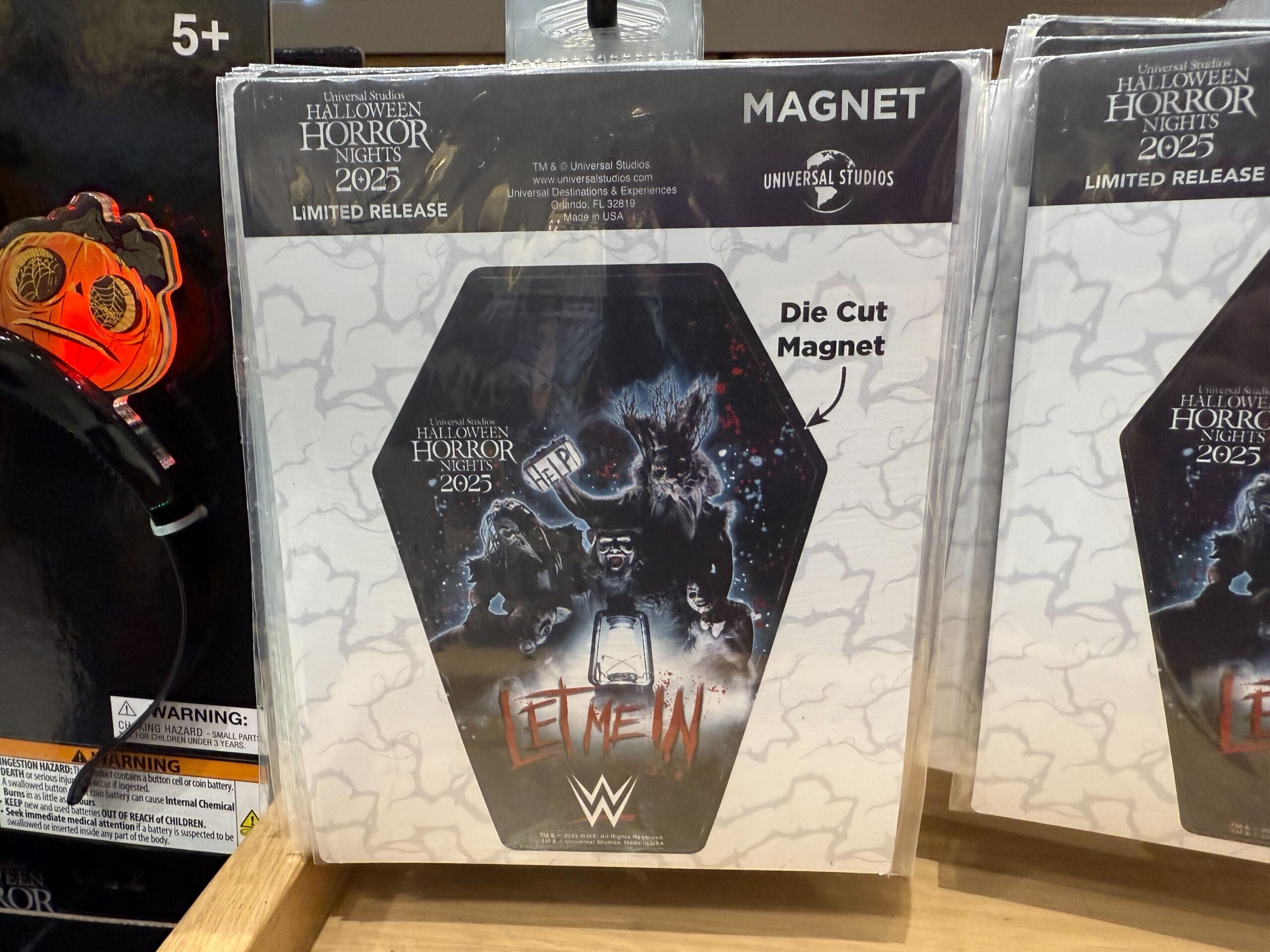 A die-cut magnet features WWE’s “Let Me In” artwork, perfect HHN Merch 2025 for Universal Orlando Resort collectors.