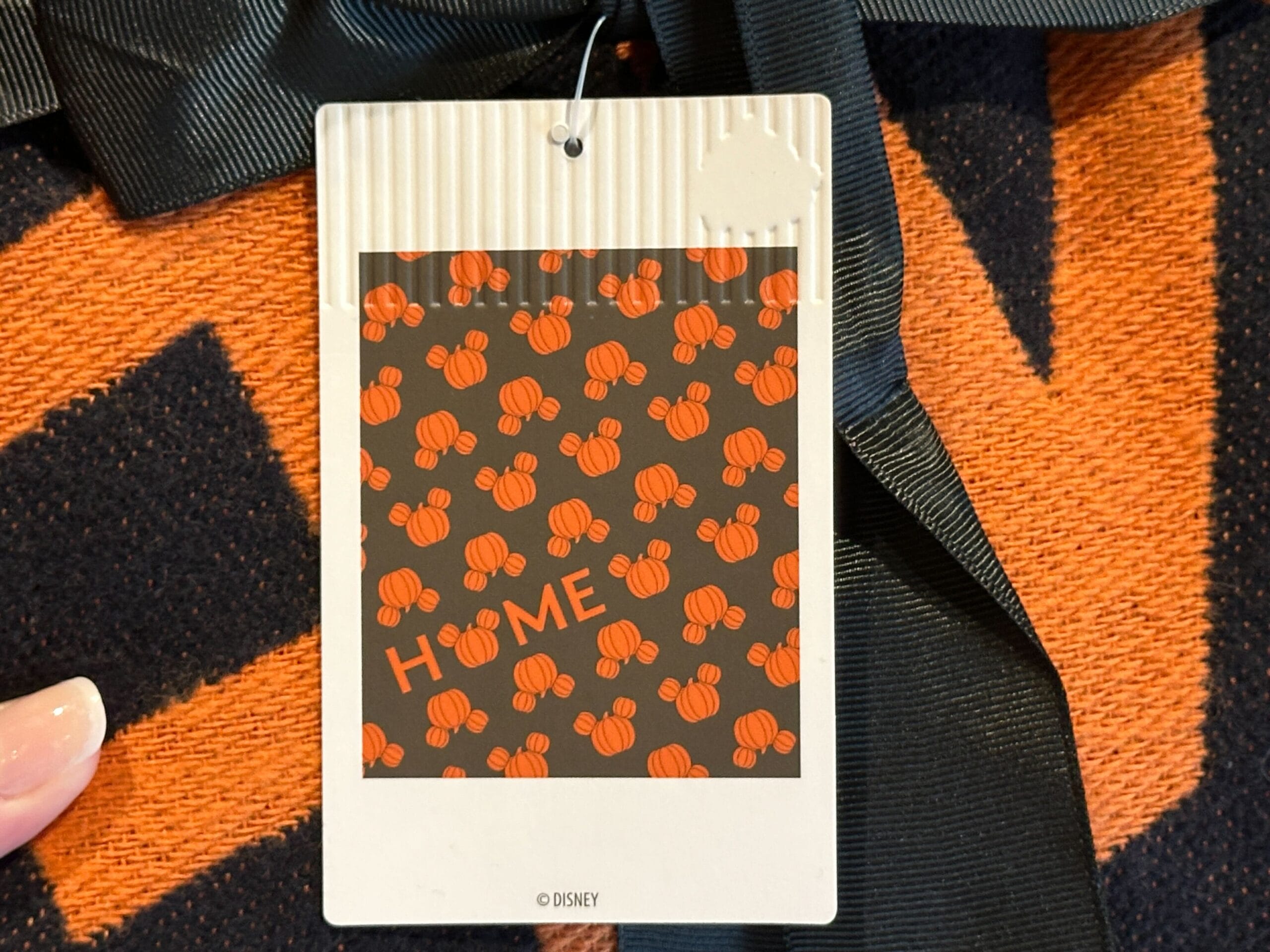 Throw blanket for Halloween featuring orange Mickey pumpkins and "HOME" on a black background.