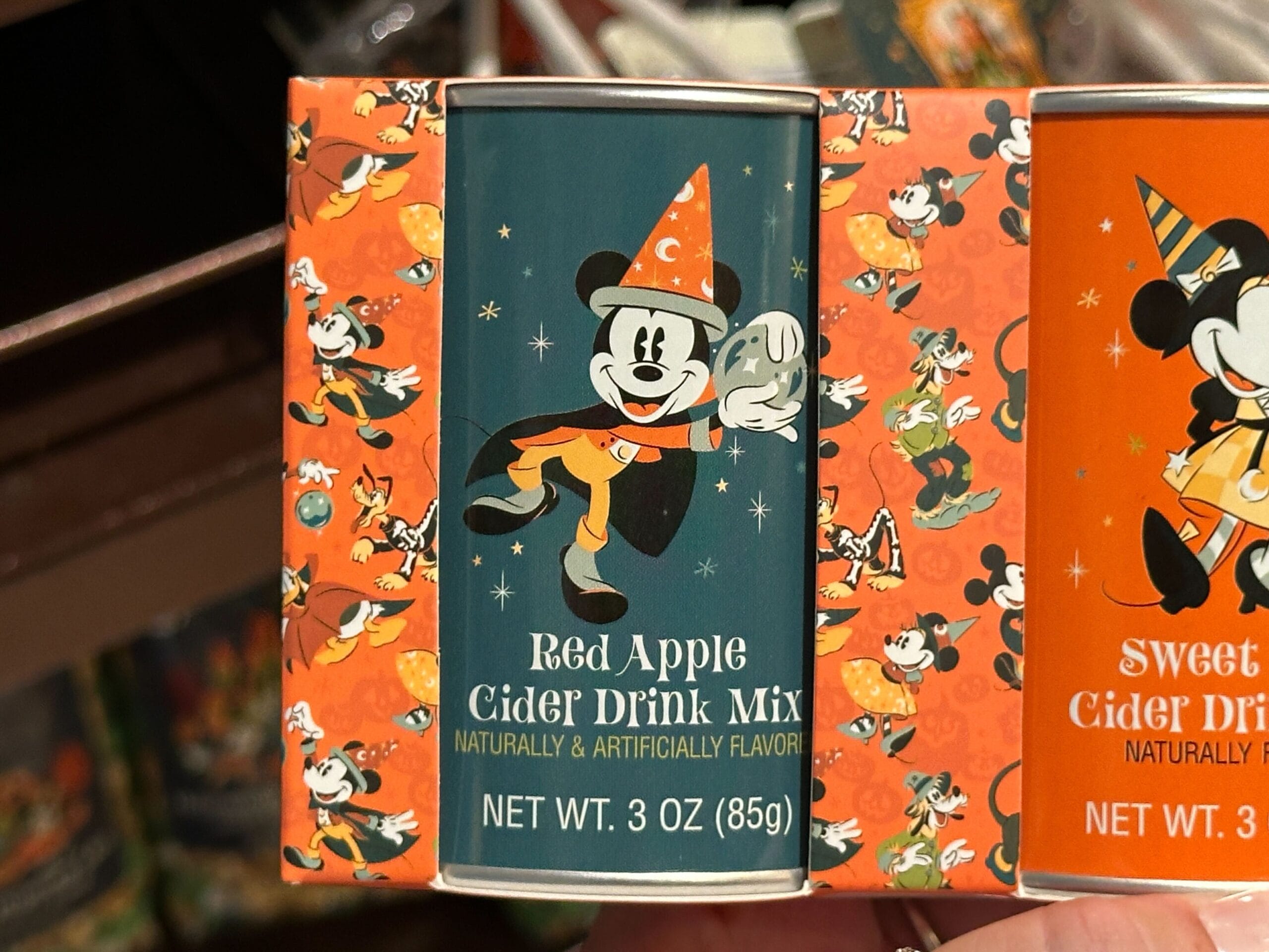 A can of Red Apple Cider Drink Mix featuring Mickey Mouse in costume—a Disney Halloween Merch 2025 exclusive.