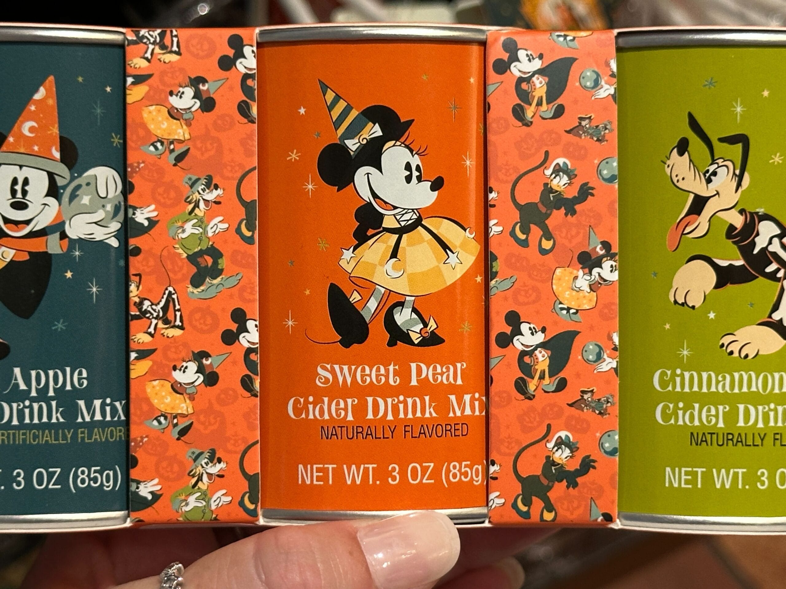Three Disney Halloween Merch drink mixes feature Mickey, Minnie, and Goofy in fun costumes and flavors for 2025.