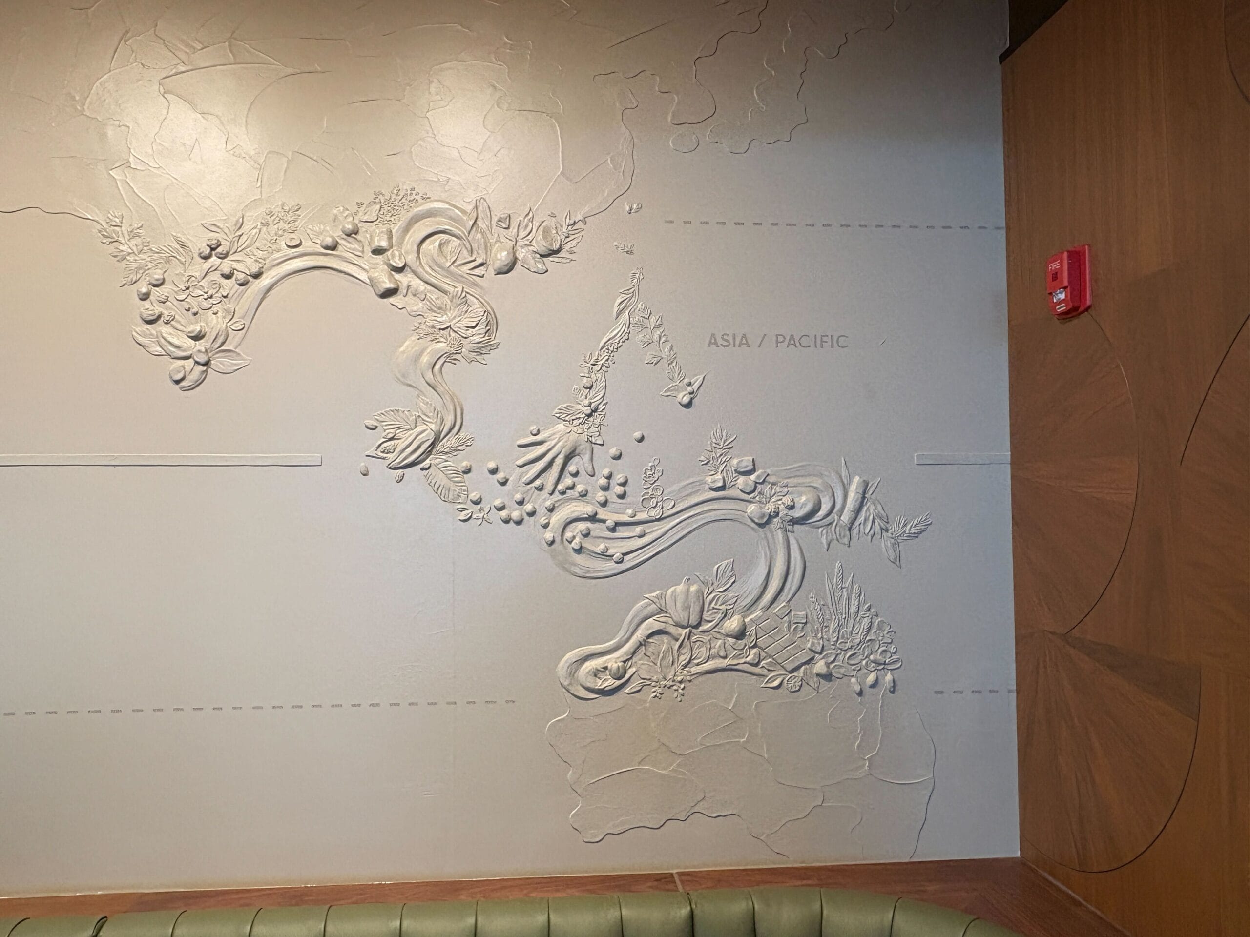 Textured wall art with organic, floral designs in a modern space near Starbucks at Disney Springs.