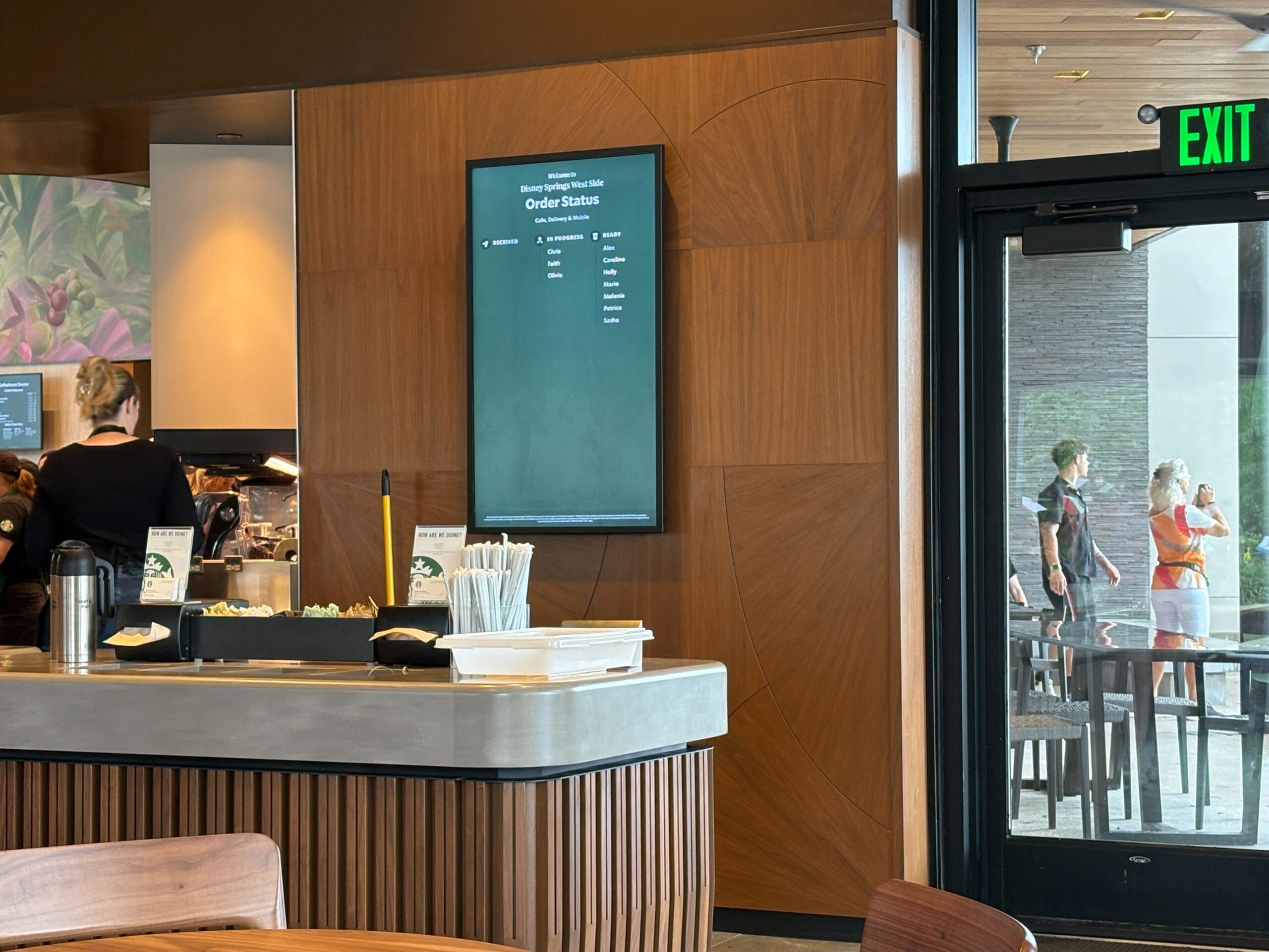 A Starbucks counter with a digital order screen, set at Disney Springs during its recent refurbishment.