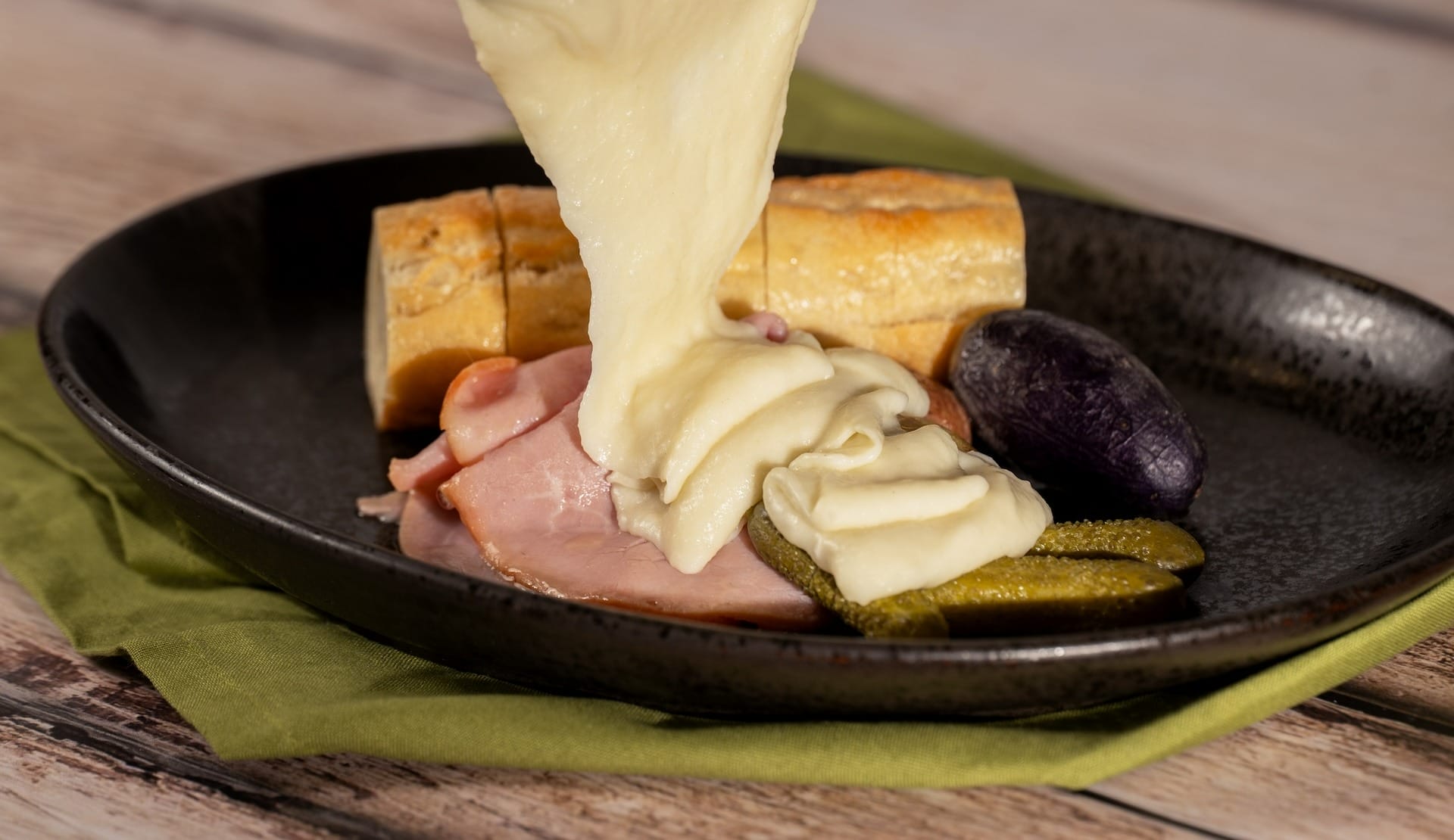 Cheese melting over ham, pickles, and baguette—a taste of the 2025 menus at the EPCOT Food & Wine Festival.