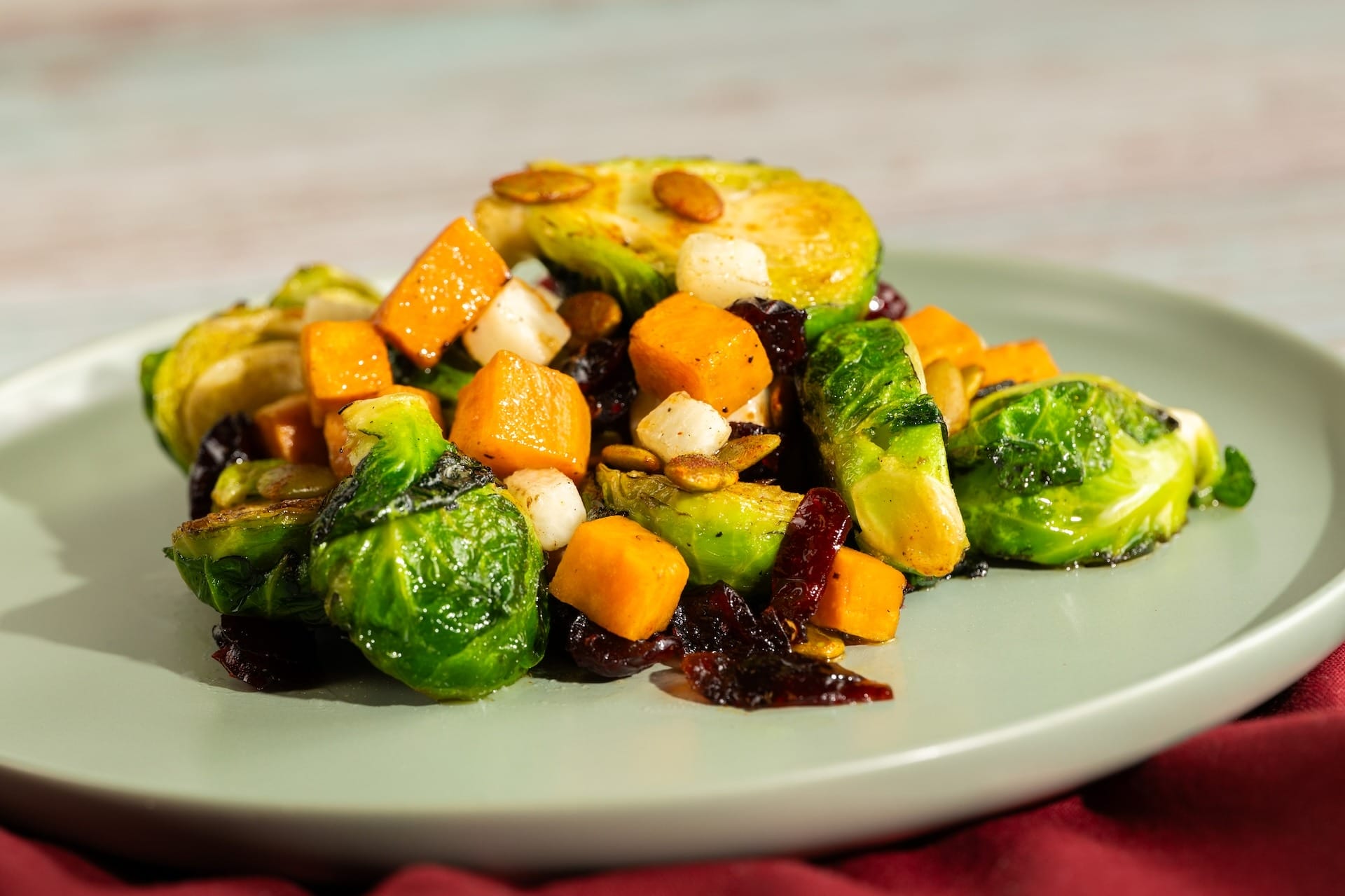 Roasted Brussels sprouts, sweet potatoes, cheese cubes, and cranberries featured on 2025 Food & Wine Festival menus.